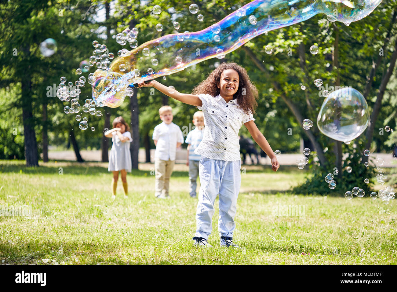 Little Girl Making Soap Bubbles Stock Photo Alamy