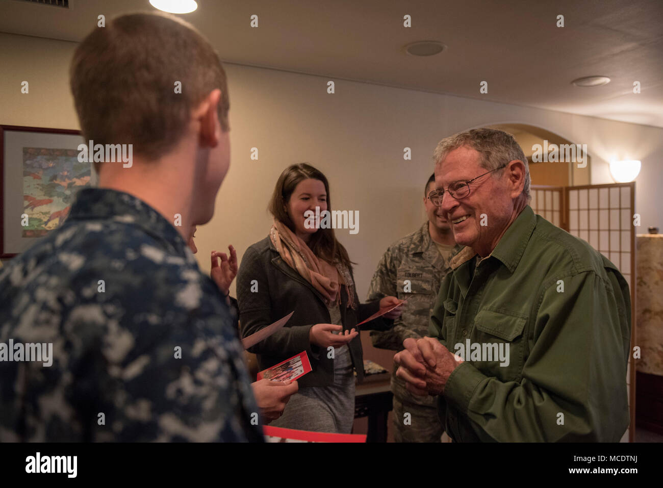 Sen. James Inhofe, R-O.K., shares cards with service members from Oklahoma during a meet and greet at Yokota Air Base, Japan, Feb. 25, 2018. Prior to departing Japan, Inhofe and other members of the congressional delegation composed of Senate and House Armed Services Committee members, took the time to thank service members from their home states for all that they do. (U.S. Air Force photo by Airman 1st Class Matthew Gilmore) Stock Photo