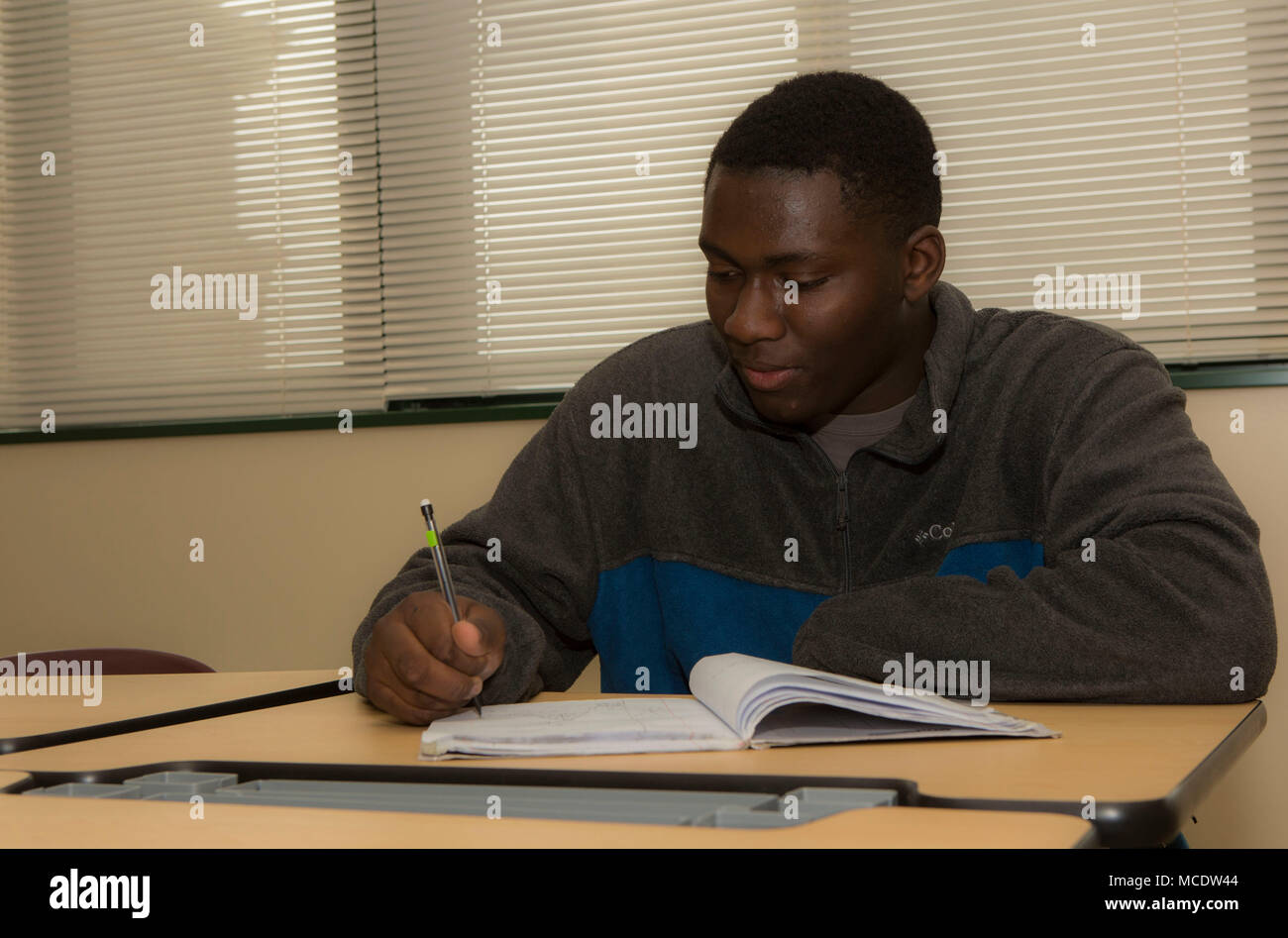 Marshall China, a sophomore at Matthew C. Perry High School, studies class notes at Marine Corps Air Station Iwakuni, Japan, Feb. 21, 2018. China believes focusing on school work is just as important as practicing for school sports. (U.S. Marine Corps photo by Lance Cpl. Muriah King) Stock Photo