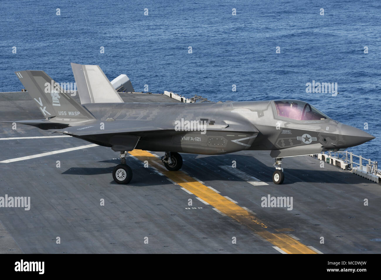 An F-35B Lightning II prepares to take off of the flight deck of the USS Wasp (LHD-1) while off the coast of Okinawa, Japan, April 13, 2018. A detachment of F-35Bs with Marine Fighter Attack Squadron 121 joined the USS Wasp for Spring Patrol 2018, marking the F-35’s first operational deployment with a MEU. As the Marine Corps’ only continuously forward-deployed MEU, the 31st Marine Expeditionary Unit provides a flexible force ready to perform a wide range of military operations throughout the Indo-Pacific region. (U.S. Marine Corps photo by Lance Cpl. Amy Phan/Released) Stock Photo
