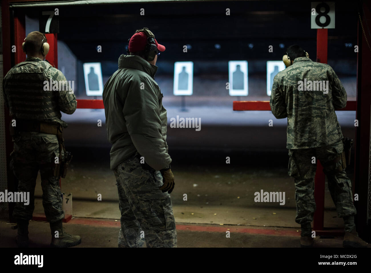 Airmen from the 71st Flying Training Wing fire their pistols at the Combat Arms Training and Maintenance range, Vance Air Force Base, Feb. 21, 2018. Instructors at CATM ensure Airmen are fit to fight by training them on proper rifle etiquette, safety procedures and how to efficiently fire weapons. (U.S. Air Force photo by Tech. Sgt. Erik Cardenas) Stock Photo