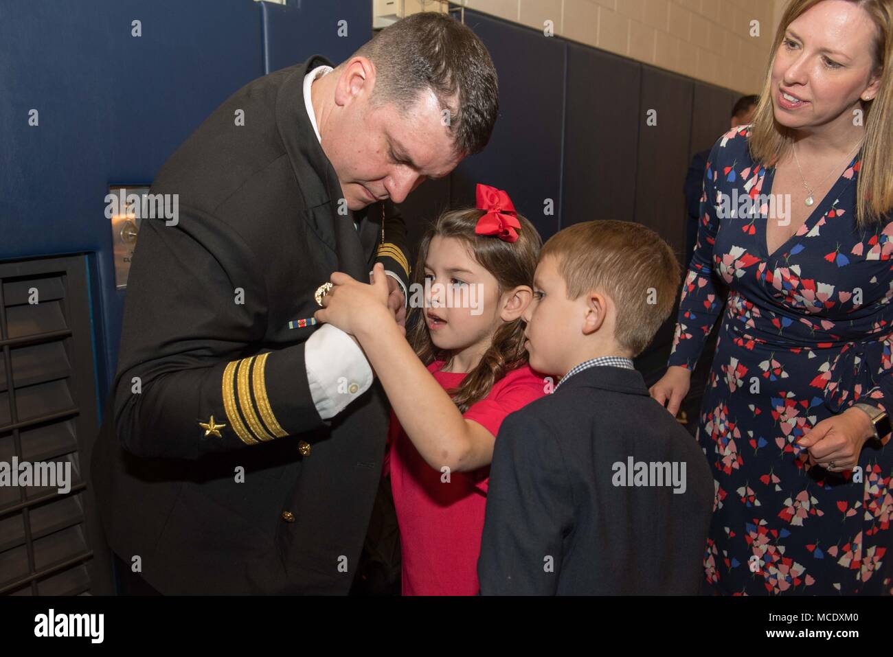 180223-N-TB148-227 CHINHAE, Republic of Korea (Feb. 23, 2018) Cmdr. Jeremy R. Ewing is pinned with his command ashore pin by his children during a change-of-command ceremony for Commander, Fleet Activities Chinhae (CFAC). During the ceremony, Ewing relieved Cmdr. Terry P. McNamara, becoming CFAC's 18th commander. (U.S. Navy photo by Mass Communication Specialist Seaman William Carlisle) Stock Photo