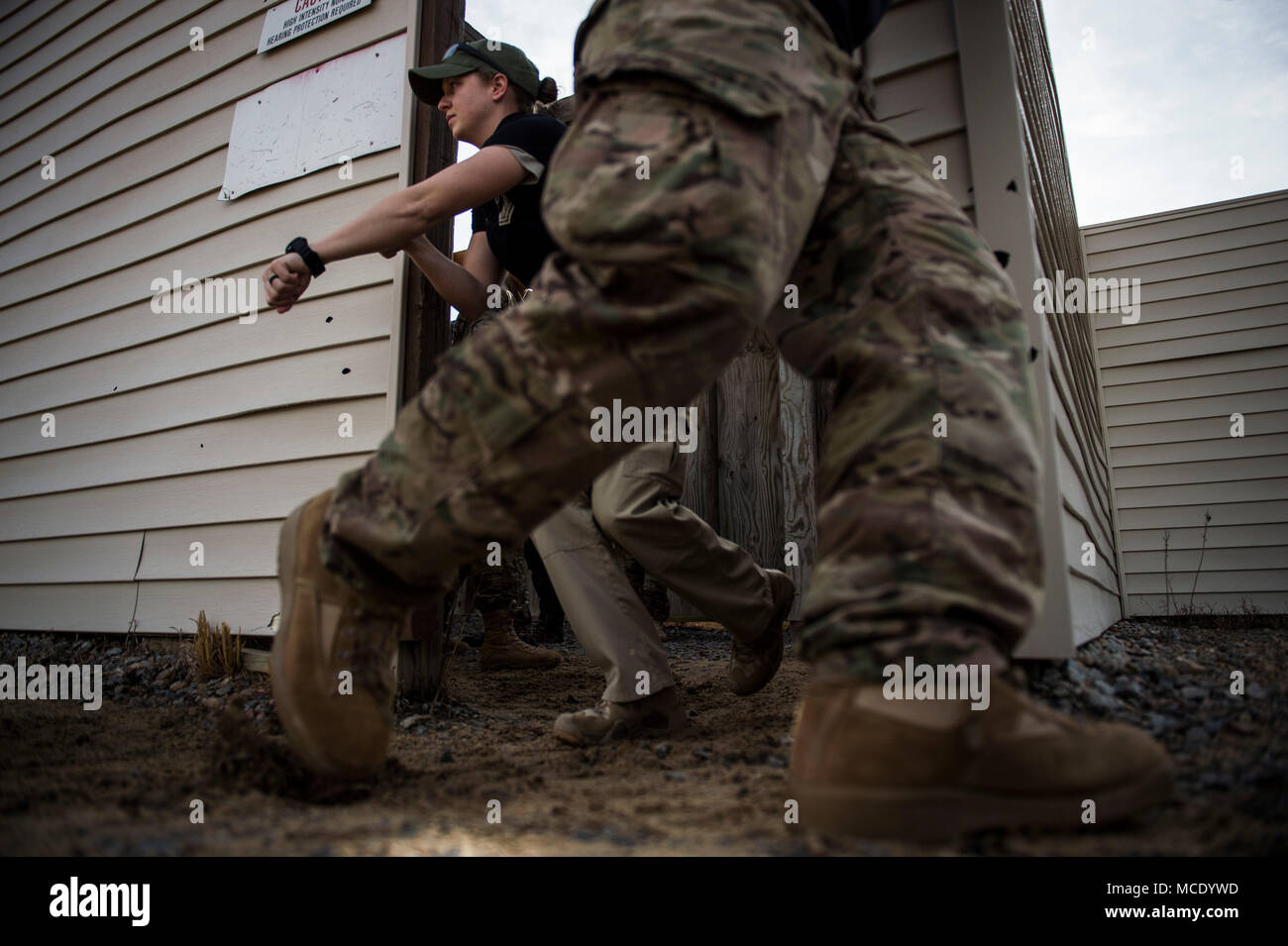 Tech. Sgt. Laura Beckley, video training and standardization non-commissioned officer in charge, demonstrates close quarters combat procedures during Exercise Scorpion Lens 2018, at Fort Jackson, South Carolina, Feb. 12, 2018. Exercise Scorpion Lens is an annual Ability to Survive and Operate training exercise mandated by Air Force Combat Camera job qualification standards. Held at the United States Army Training Center Fort Jackson, S.C., and the McCrady Training Center, Eastover, S.C., the exercise's purpose is to provide refresher training to combat camera personnel. Individuals are instruc Stock Photo