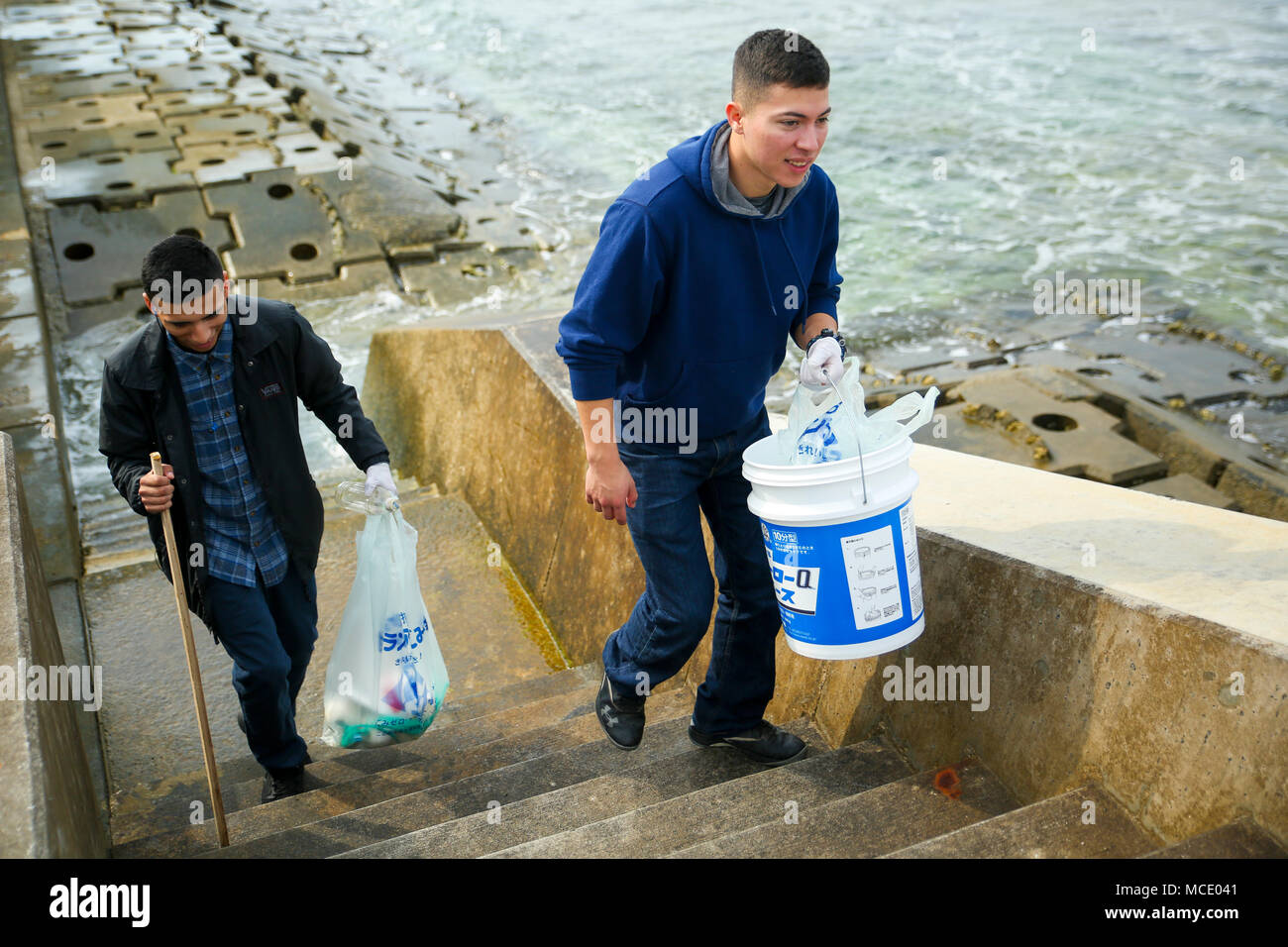 SUNABE SEAWALL, OKINAWA, Japan- Lance Cpl. Xavier Hernandez, left, and Lance Cpl. Victor Diaz collect trash Feb. 24 at Sunabe Seawall, Okinawa, Japan. Twenty-one Marines with the Single Marine Program from Camp Courtney visited the seawall to help cleanup debris along the beach. Diaz and Hernandez are network administrators with Headquarters Battalion, 3rd Marine Division. (U.S. Marine Corps photo by Pfc. Nicole Rogge) Stock Photo