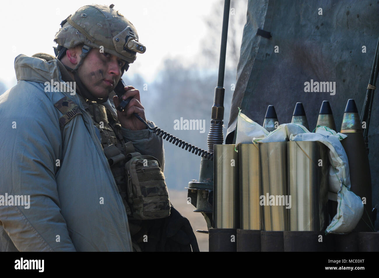 U.S. Army Spc. Tyler Jouret, assigned to Battery A, 4th Battalion, 319th Airborne Field Artillery Regiment, 173rd Airborne Brigade, operates a radio during a live fire exercise as part of exercise 'Bayonet Sphinx' at the 7th Army Training Command's Grafenwoehr Training Area, Germany, Feb. 27, 2018.  (U.S. Army photo by Markus Rauchenberger) Stock Photo