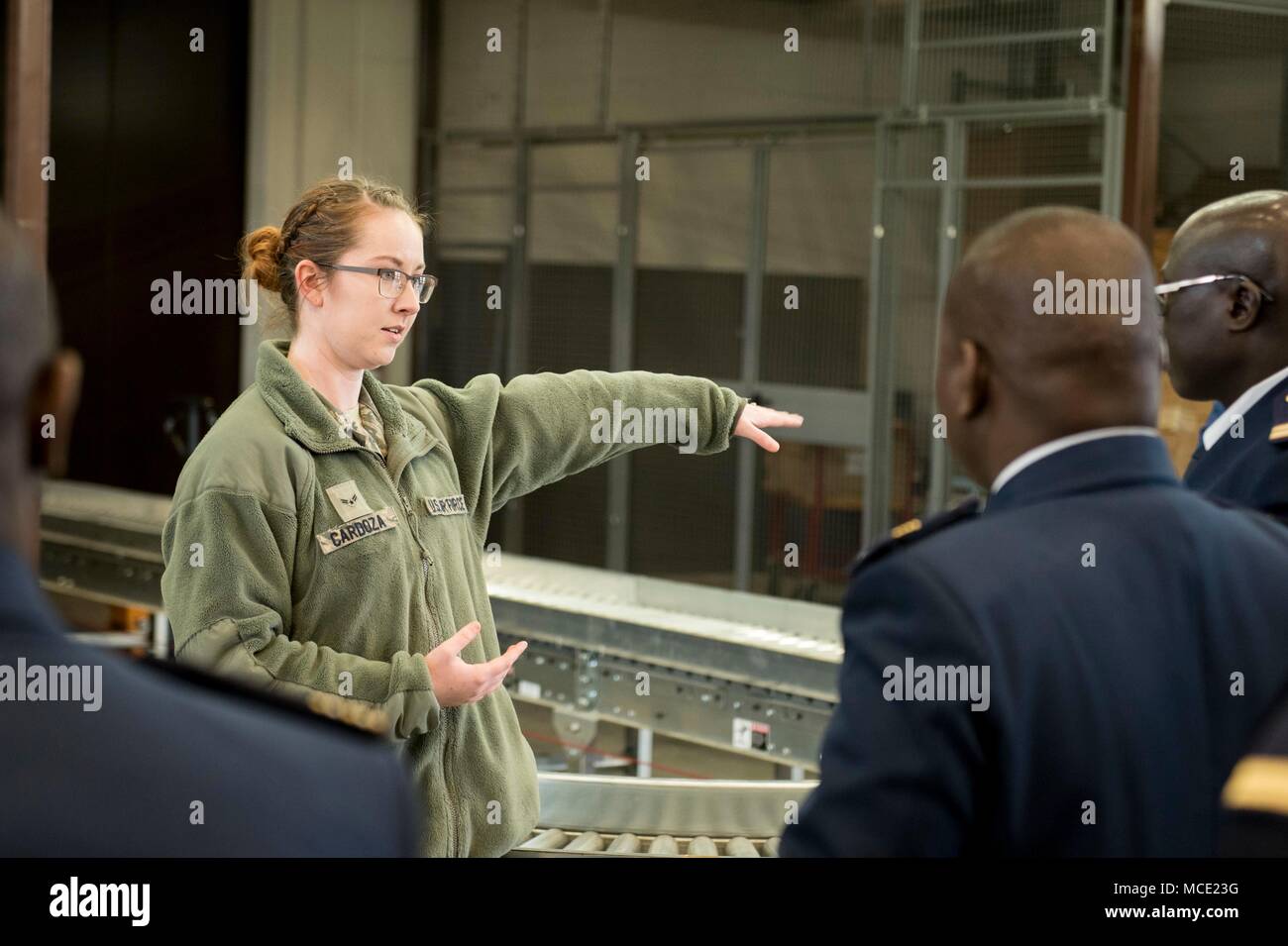 Airman 1st Class Megan Cardoza, 52nd Logistics and Readiness Squadron Traffic Management Clerk, explains the outgoing cargo procedures to a delegation of Senegalese Air Force leadership at Spangdahlem Air Base, Feb. 14, 2018. This program was developed by U.S. Air Force Europe and Air Forces Africa to build partnership capacity with African allies and assist in the building and modernization of their respective organizations. Participants tour active U.S. air bases to view their functions as a working model and use the information gathered to better organize and grow their own air force's capa Stock Photo