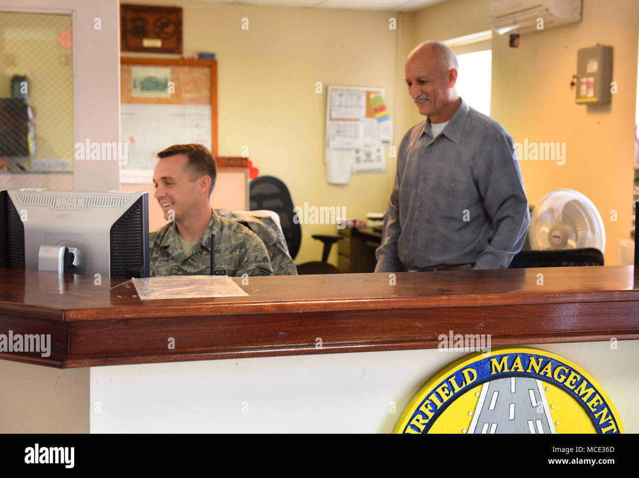 U.S. Air Force Staff Sgt. Steven Lucas (left) and Mr. José Anariba, 612th  Air Base Squadron work at the Airfield Management headquarters at Soto Cano Air Base, Honduras, Feb. 22, 2018. Airfield Management personnel are responsible for airfield activities such as construction, aircraft arrival and departure coordination with the Honduran Air Force, and emergency response. (U.S. Army photo by Maria Pinel) Stock Photo