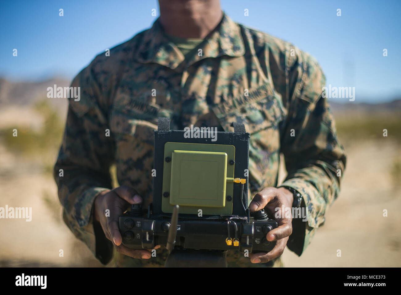 U.S. Marine Corps Cpl. Justin Johnson, with 3rd Battalion, 7th Marine  Regiment, 1st Marine Division, remote controls an InstanEye quadcopter,  during a Quads for Squads training event on Marine Corps Air Ground