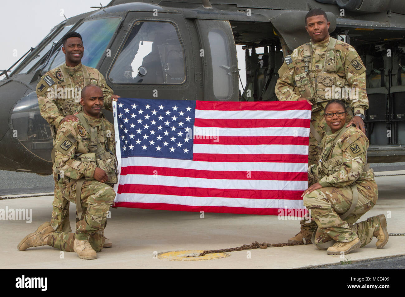 Captain Echette Washington, Chief Warrant Officer 3 Troy Willis, Sgt. John Chambliss, and Staff Sgt. Jackie Edwards from Alpha Company, “Task Force Voodoo”, 1st Assault Helicopter Battalion, 244th Aviation Regiment, Louisiana National Guard pose on the flight line, Camp Buehring, Kuwait, Feb. 27, 2018. The flight featured an all-African-American crew in recognition of Black History Month and the growth that has occurred within the aviation community over time. (U.S. Army photo by Sgt. Thomas X. Crough, USARCENT PAO) Stock Photo