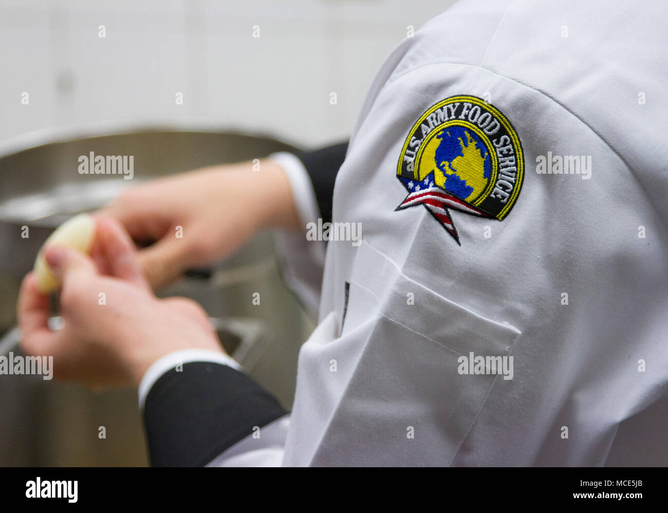 Chef coats, black pants, black boots and black chef hats are the