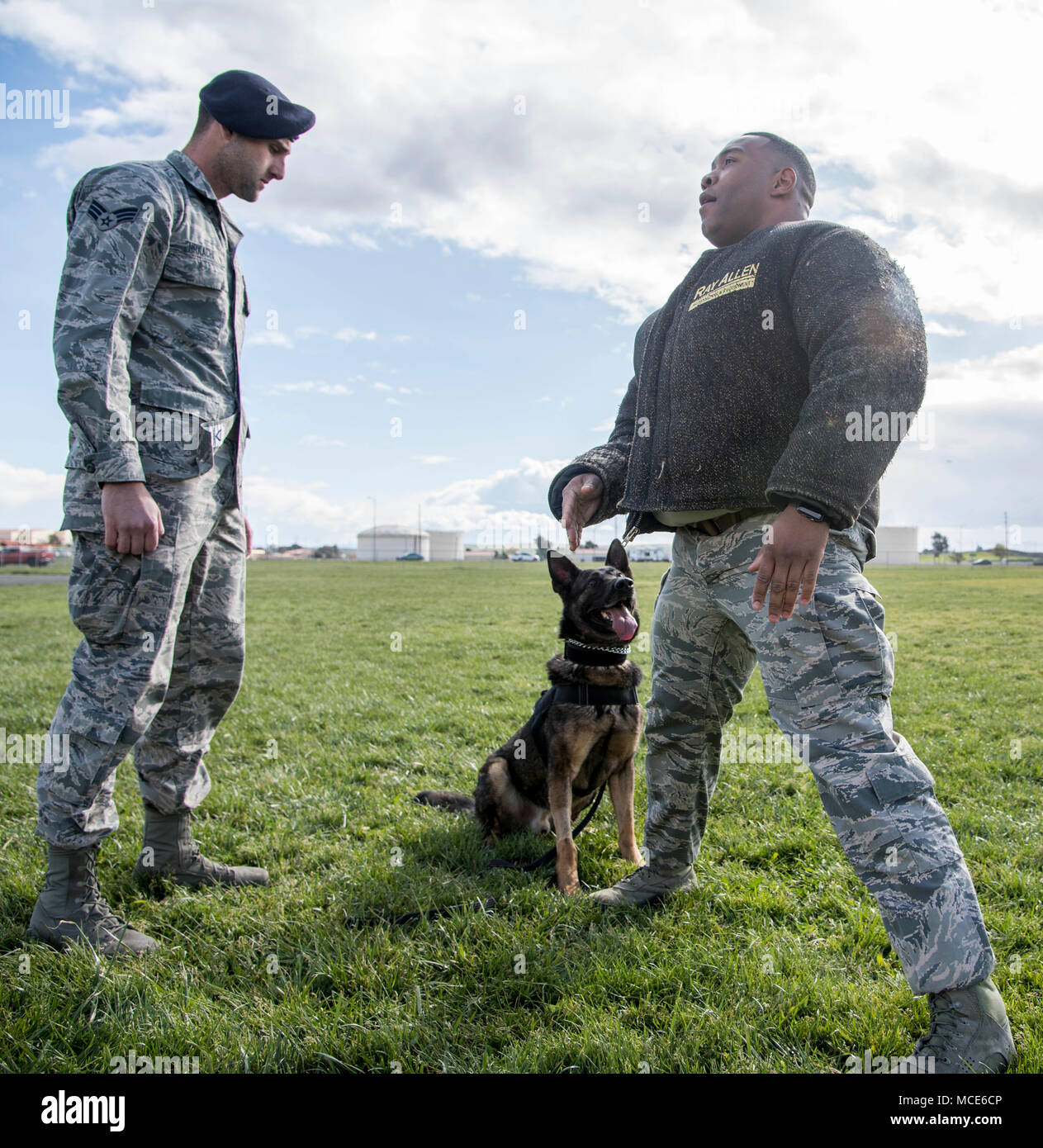 Senior Airman Jordan Hrkach, 60th Security Forces Military Working Dog  handler, and Pako, 60th SFS MWD, put on a demonstration at the Travis  Elementary school with Master Sgt. Roberto Cheesboro, 60th SFS,