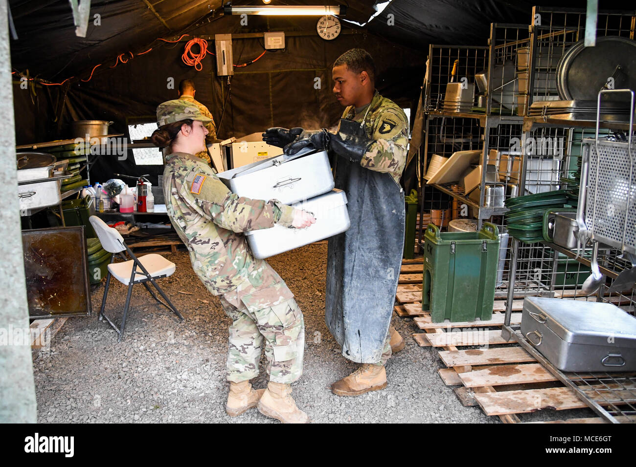 Pvt. Kaylee Jasper, a food service specialist with E. Company, 6th General Support Battalion, 101st Combat Aviation Brigade, 101st Airborne Division (Air Assault) delivers clean pans to the kitchen February 28, 2018, at Fort Campbell, Ky., during the 50th Annual Phil-lip A. Connelly Competition. 'Just being here helped me learn a lot more than I ever could being in a dining facility,' said Jasper. 'This will definitely shape someone and if I re-enlist it will be because of Connelly.' (U.S. Army photo by Sgt. Marcus Floyd, 101st Combat Aviation Brigade) Stock Photo