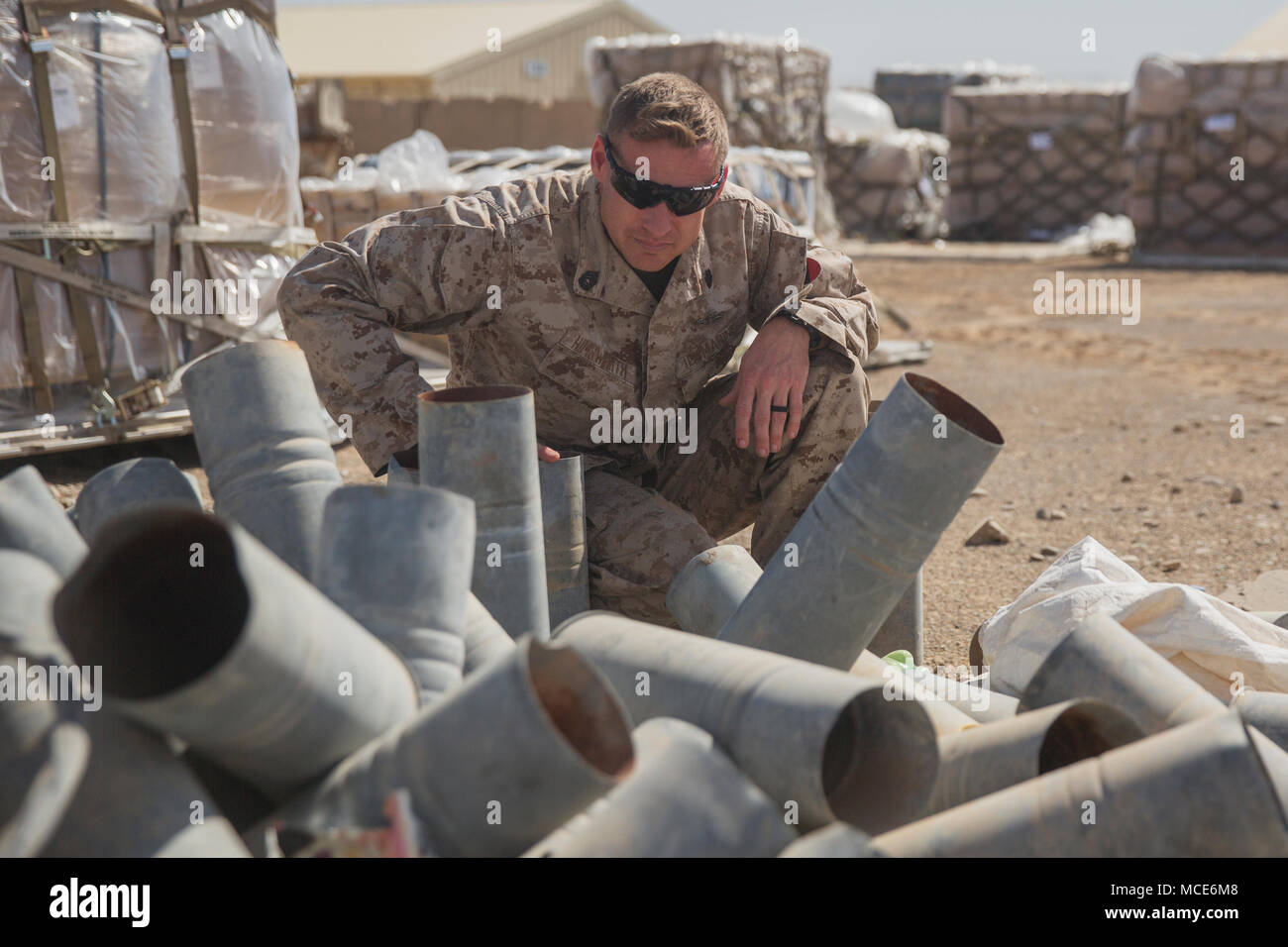 A Us Marine With Task Force Southwest Examines Empty Shell Casings To