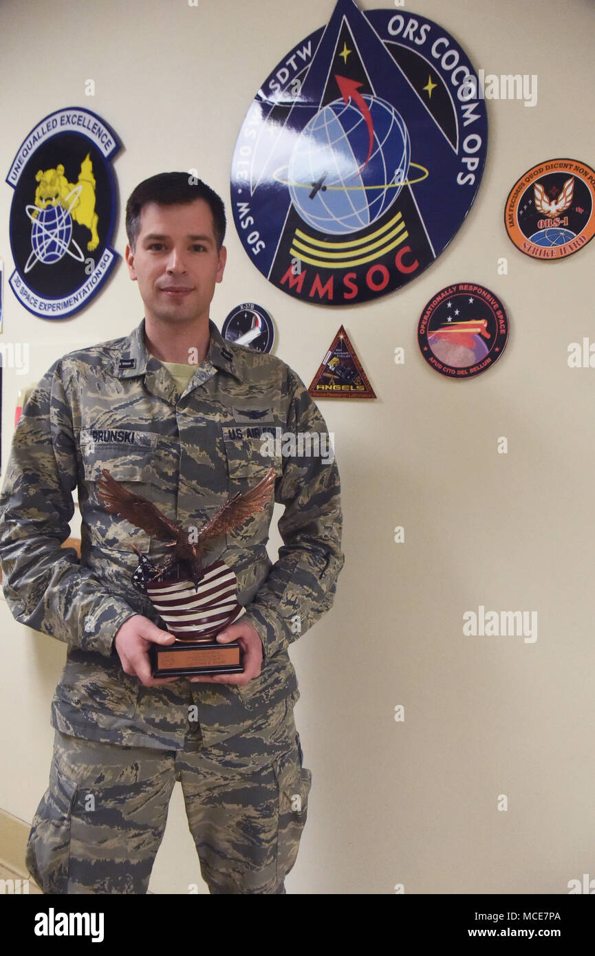 Capt. Daniel Brunski, flight mission planner with the 3rd Space Experimentation Squadron stands with his 50th Space Wing’s 2017 Innovator of the Year award. Brunski worked alongside the 527th and 26th Space Aggressor Squadrons and 25th Space Range Squadron to develop exercise events. (U.S. Air Force photo by Senior Airman Arielle Vasquez) Stock Photo
