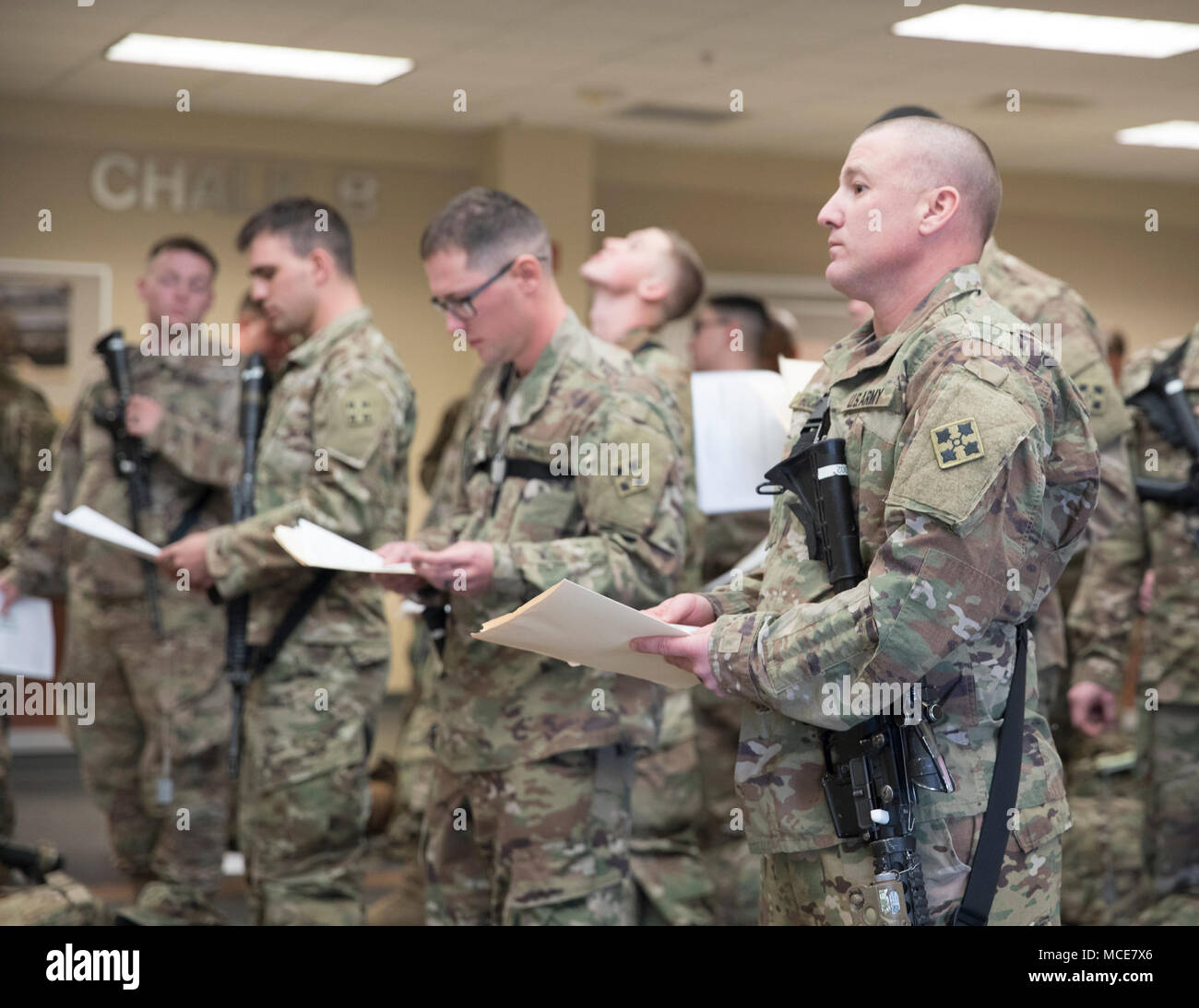 Soldiers from the 3rd Squadron, 61st Cavalry Regiment, 2nd Infantry Brigade Combat Team, 4th Infantry Division, wait in line for inspection, Feb. 19, 2018, before boarding an aircraft to depart Fort Carson, Colorado and begin their ten-month deployment to Kosovo. (U.S. Army photo by Staff Sgt. Neysa Canfield/ 2IBCT Public Affairs) Stock Photo