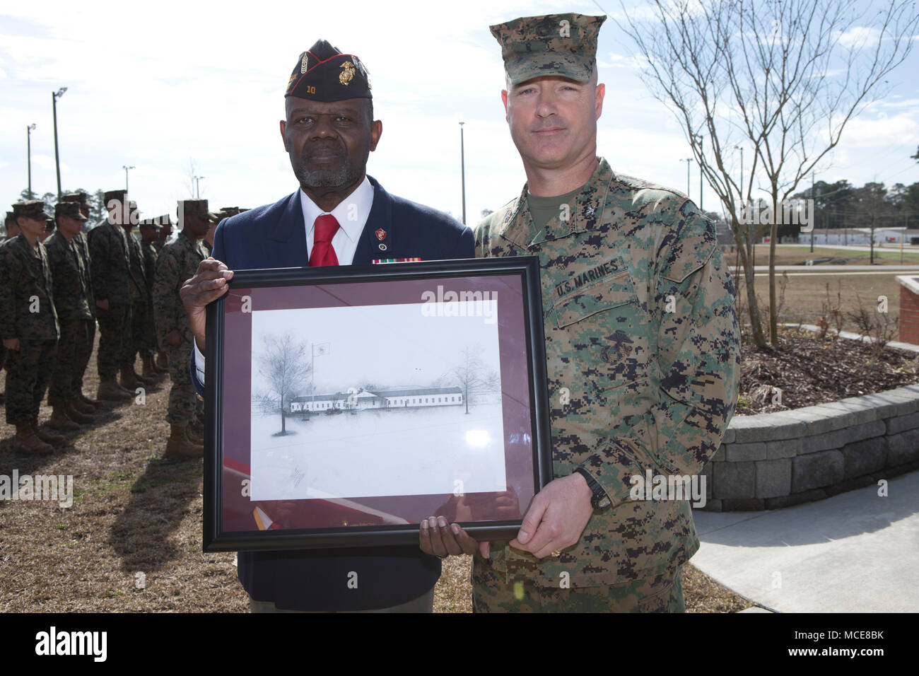 U.S. Marine Corps Col. David P. Grant, right, commanding officer of Marine Corps Combat Service Support Schools, presents a gift to Sgt. Maj. Johnny B. Young, USMC (Ret.) at Camp Johnson, N.C., Feb. 15, 2018. Marines and civilians gathered at the Montford Point Museum to celebrate African American History Month. (U.S. Marine Corps photo by Lance Cpl. Luis E. Zamot III) Stock Photo