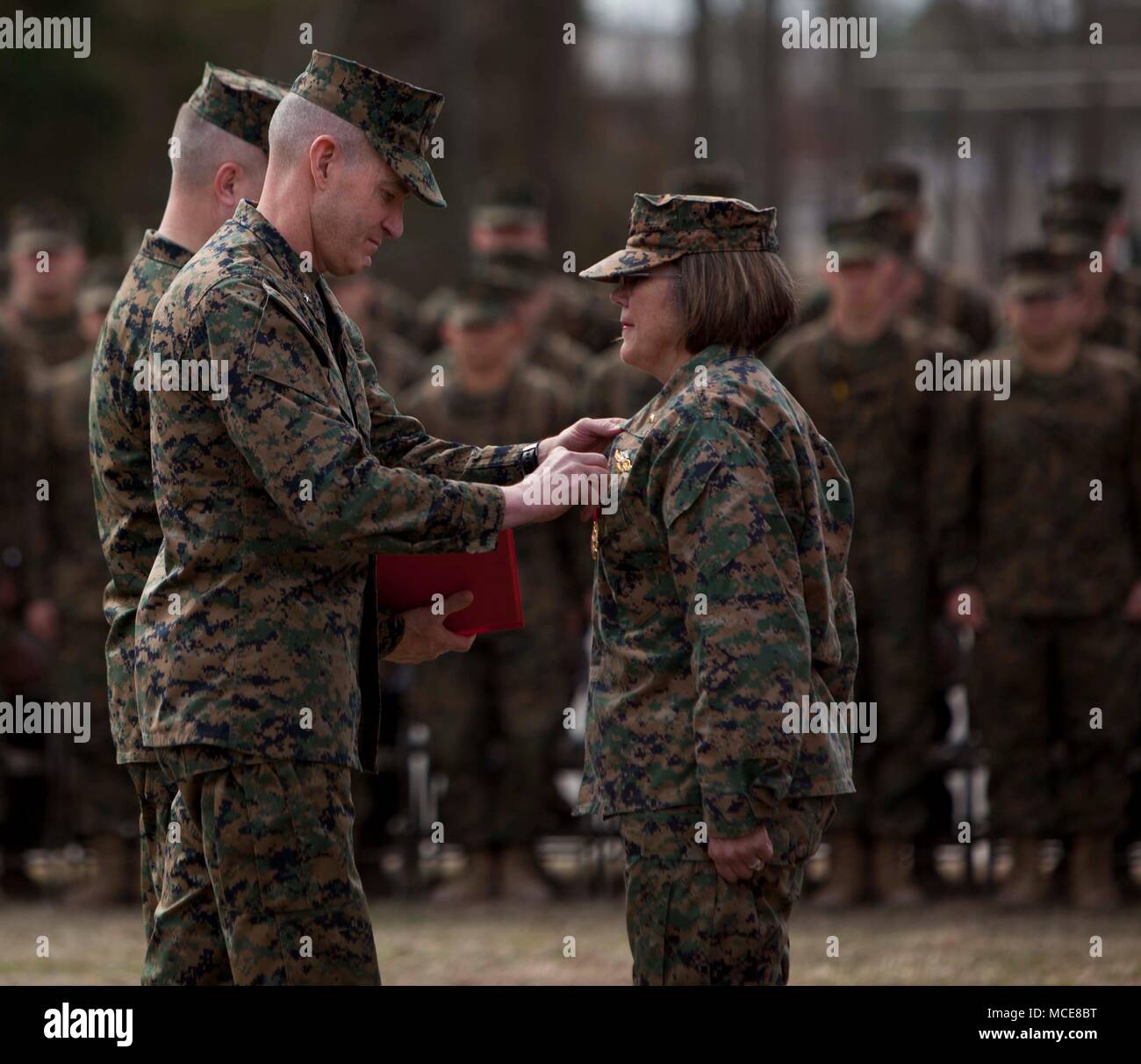 U.S. Marine Corps Training Command Commanding General Brig. Gen. Jason Q. Bohm, left, awards the Legion of Merit to U.S. Navy Capt. Jennifer E. Smith during the Field Medical Training Battalion-East (FMTB-E) Change of Command ceremony on Camp Johnson, N.C. Jan. 9, 2018. The Change of Command ceremony is a time-honered tradition in which one commander reliquishes command to another. (U.S. Marine Corps photo by Lance Corporal Tyler Pender) Stock Photo