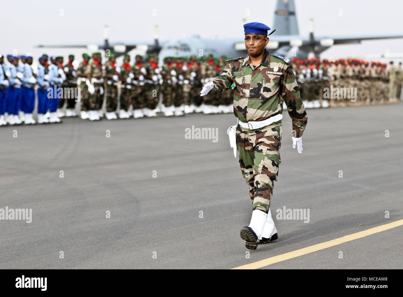 NIAMEY, Niger –  A Nigerian Soldier marches across the airfield at the start of the opening ceremony of Flintlock 2018 in Niamey, Niger, April 11, 2018. Flintlock, hosted by Niger, with key outstations at Burkina Faso and Senegal, is designed to strengthen the ability of key partner nations in the region to counter violent extremist organizations, protect their borders, and provide security for their people. (U.S. Army Photo by Sgt. Heather Doppke/79th Theater Sustainment Command) Stock Photo