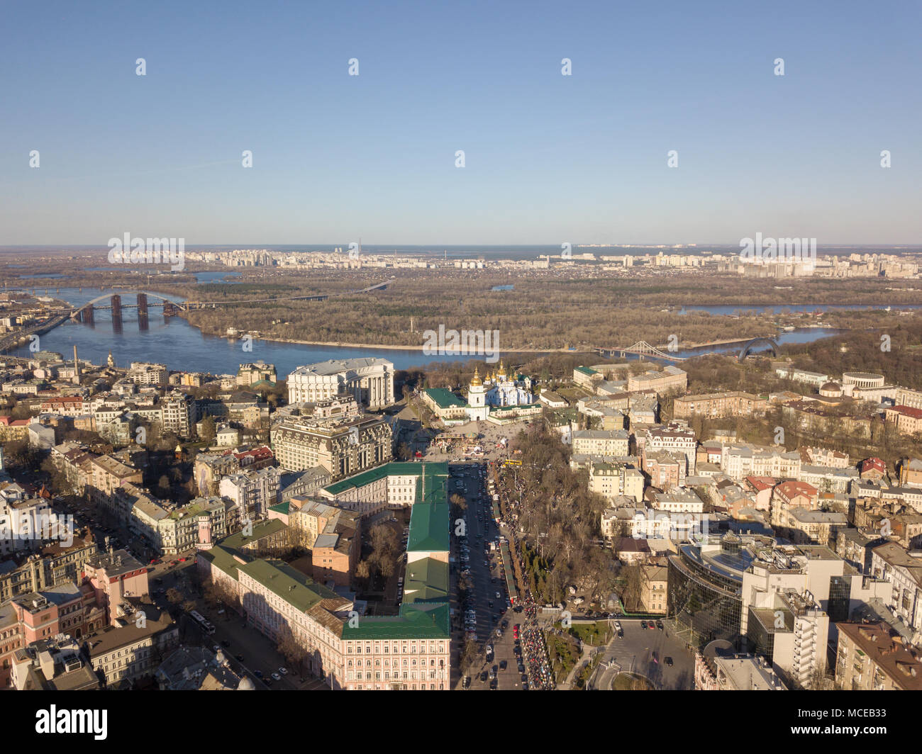 Aerial view district Podol, the Dnieper River and Trukhanov island on a sunny afternoon. St. Vladimir's Cathedral church in the distance Kyiv, Ukraine Stock Photo