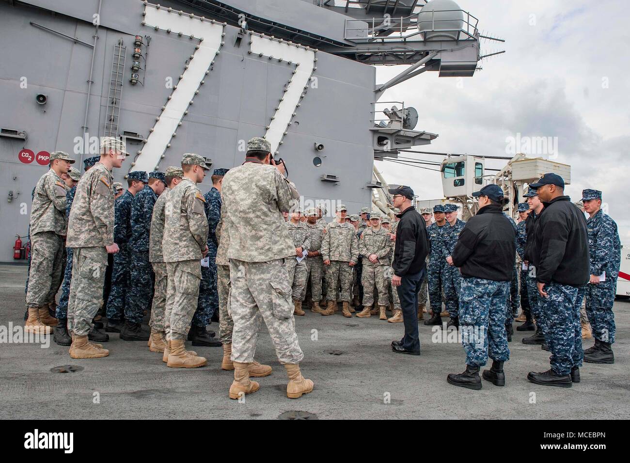 180410-N-JC445-0046 NORFOLK, Va (April 10, 2018) Senior Chief Mass Communication Specialist Mike Jones, from Keflavik, Iceland, speaks to cadets and midshipmen from the Virginia Military Institute (VMI) during a tour aboard the aircraft carrier USS George H.W. Bush (CVN 77). The ship is in port in Norfolk, Virginia, conducting sustainment exercises to maintain carrier readiness.  (U.S. Navy photo by Mass Communication Specialist 3rd Class Mario Coto) Stock Photo