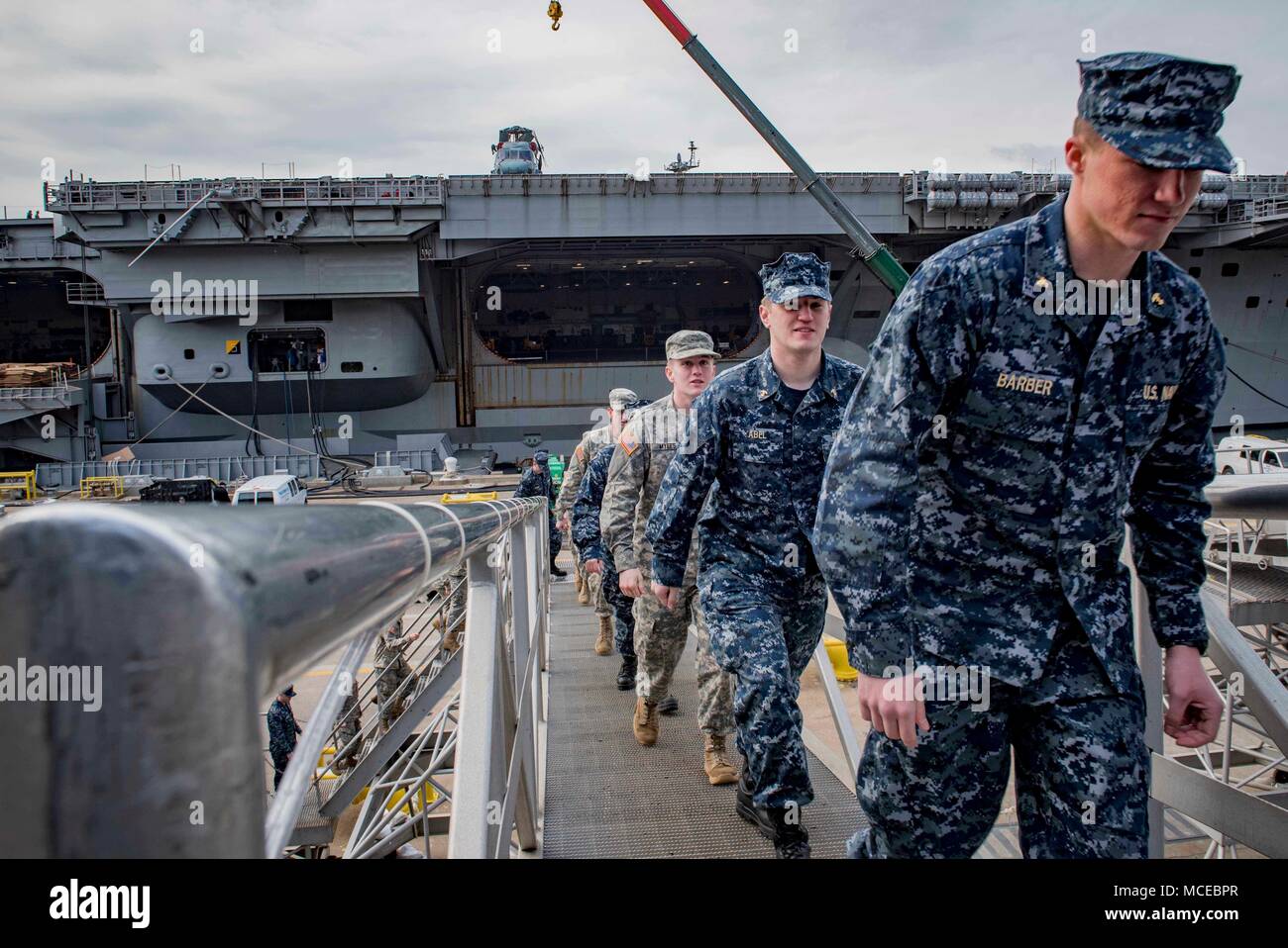 180410-N-SO730-0024 NORFOLK, Va (April 10, 2018) Cadets and midshipmen from the Virginia Military Institute (VMI) walk up the brow aboard the aircraft carrier USS George H.W. Bush (CVN 77) for a tour. The ship is in Norfolk, Virginia conducting sustainment exercises to maintain carrier readiness. (U.S. Navy photo by Mass Communication Specialist 3rd Class Joe Boggio) Stock Photo