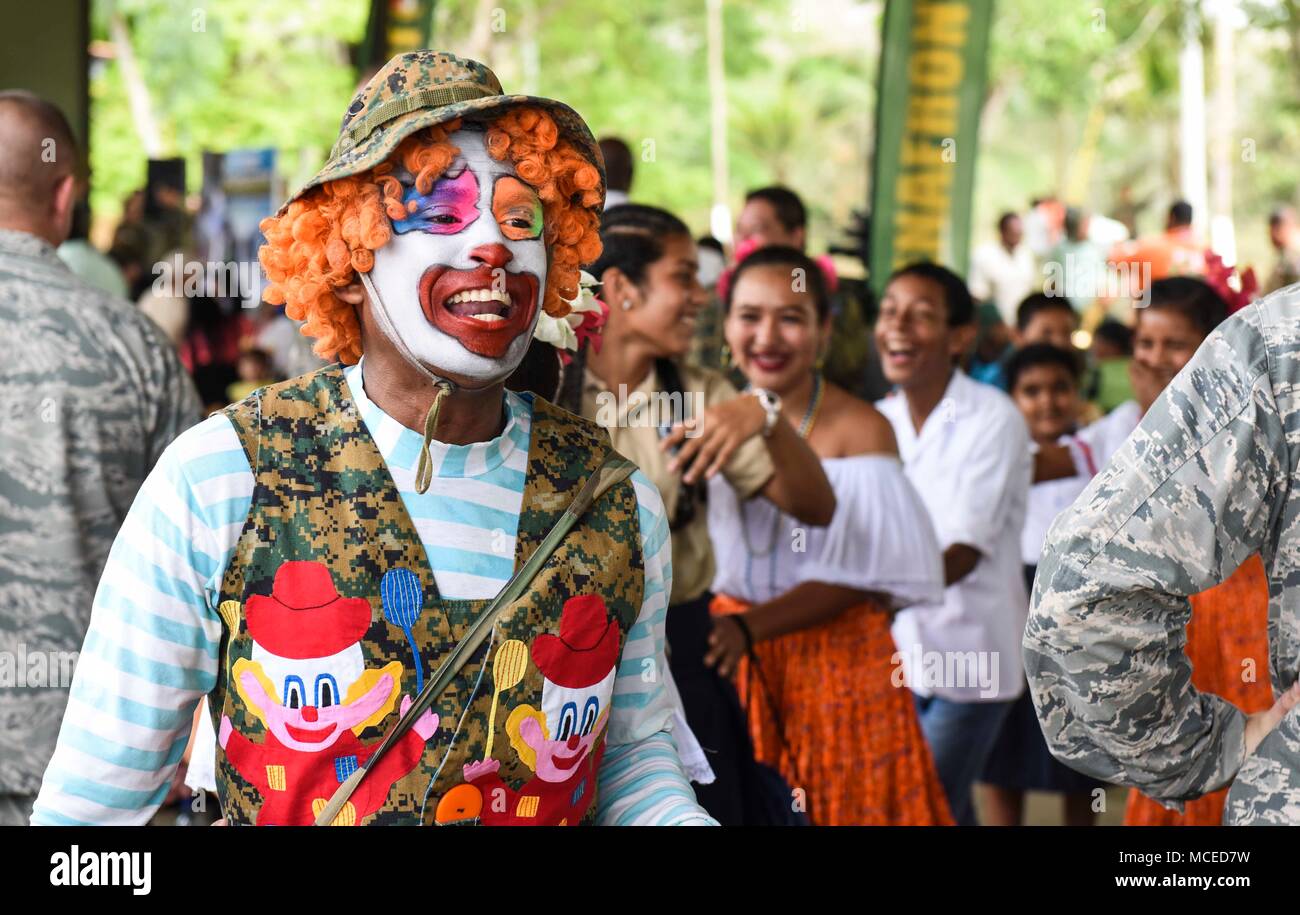 A clown leads a line of guests through a crowd at the opening ceremony of Exercise New Horizons 2018 April 11, 2018, in Meteti, Panama. Exercise New Horizons is a deployed, joint training operation, focused on enhancing relations with partner nations, providing aid to local communities and providing training U.S. military members. During the exercise, U.S. military members will build three schools, one community center and a women’s health ward in the Meteti area. They will also work closely with Panamanian health providers bringing medical aid to people in the Darien, Coclé, and Veraguas Prov Stock Photo