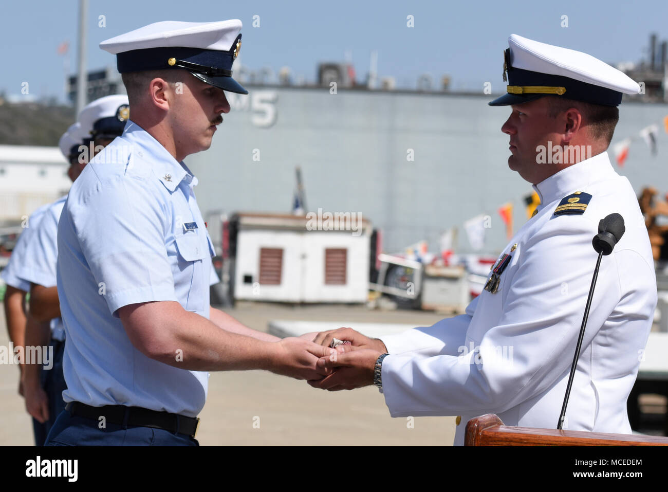 Petty Officer 3rd Class Cody Moffett, boatswain’s mate, Coast Guard Cutter Edisto, presents