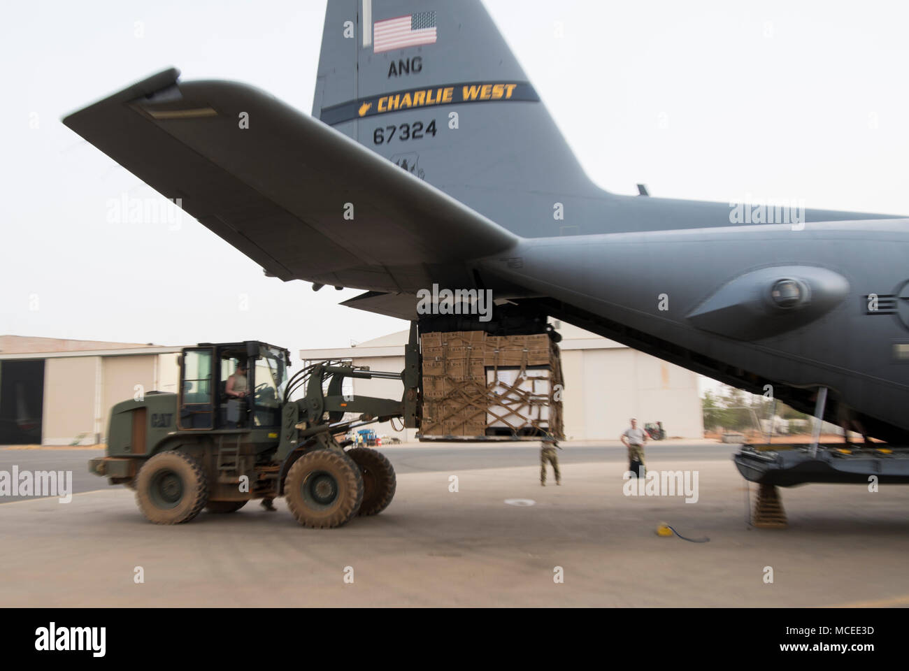 Members of the West Virginia Air National Guard load a C-130H Hercules April 10, 2018 at Diori Hamani International Airport, Niger. Approximately 1,900 service members from more than 20 African and western partner nations are participating in Flintlock 2018 at multiple locations in Niger, Burkina Faso, and Senegal. Flintlock is an annual, African-led, integrated military and law enforcement exercise that has strengthened key partner nation forces throughout North and West Africa as well as western Special Operations Forces since 2005.  (U.S. Air Force photo/Senior Airman Clayton Cupit) Stock Photo