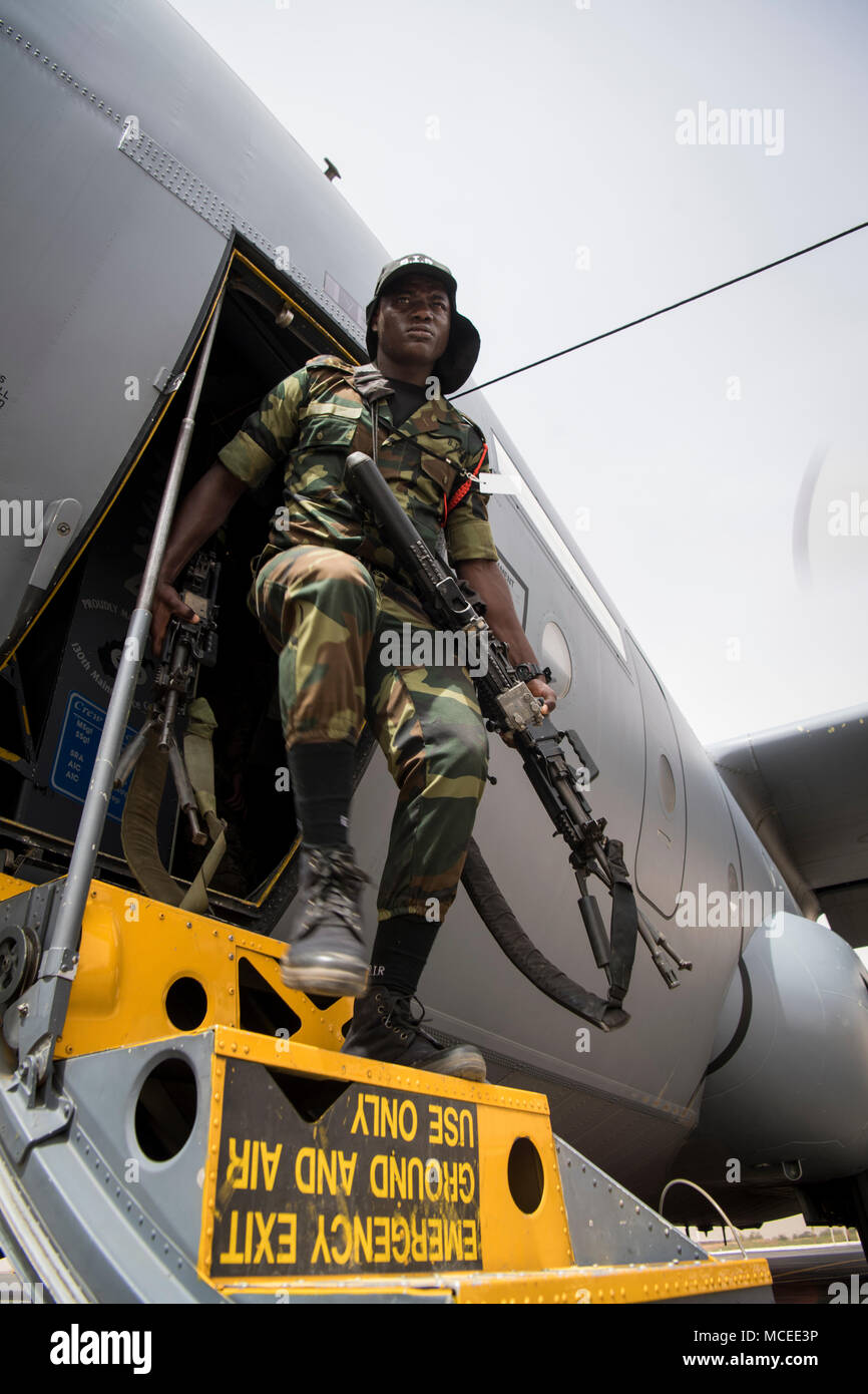 A Soldier from the Burkina Faso Army exits a U.S. Air Force C-130H Hercules April 10, 2018 at Diori Hamani International Airport, Niger. Approximately 1,900 service members from more than 20 African and western partner nations are participating in Flintlock 2018 at multiple locations in Niger, Burkina Faso, and Senegal. Flintlock is an annual, African-led, integrated military and law enforcement exercise that has strengthened key partner nation forces throughout North and West Africa as well as western Special Operations Forces since 2005.  (U.S. Air Force photo/Senior Airman Clayton Cupit) Stock Photo