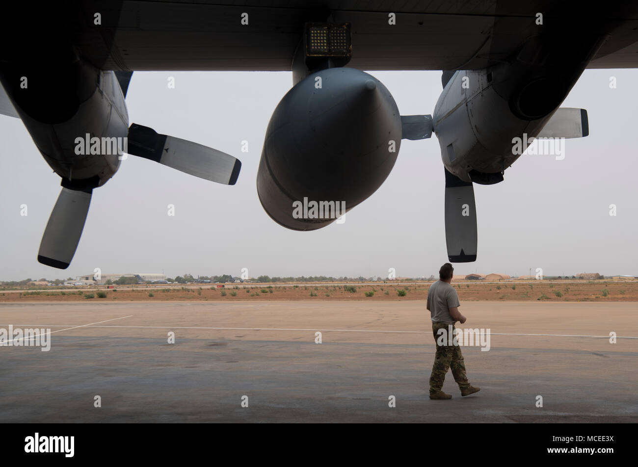 A loadmaster from the West Virginia Air National Guard inspects the propellers of a C-130H Hercules April 10, 2018 at Diori Hamani International Airport, Niger. Approximately 1,900 service members from more than 20 African and western partner nations are participating in Flintlock 2018 at multiple locations in Niger, Burkina Faso, and Senegal. Flintlock is an annual, African-led, integrated military and law enforcement exercise that has strengthened key partner nation forces throughout North and West Africa as well as western Special Operations Forces since 2005.  (U.S. Air Force photo/Senior  Stock Photo