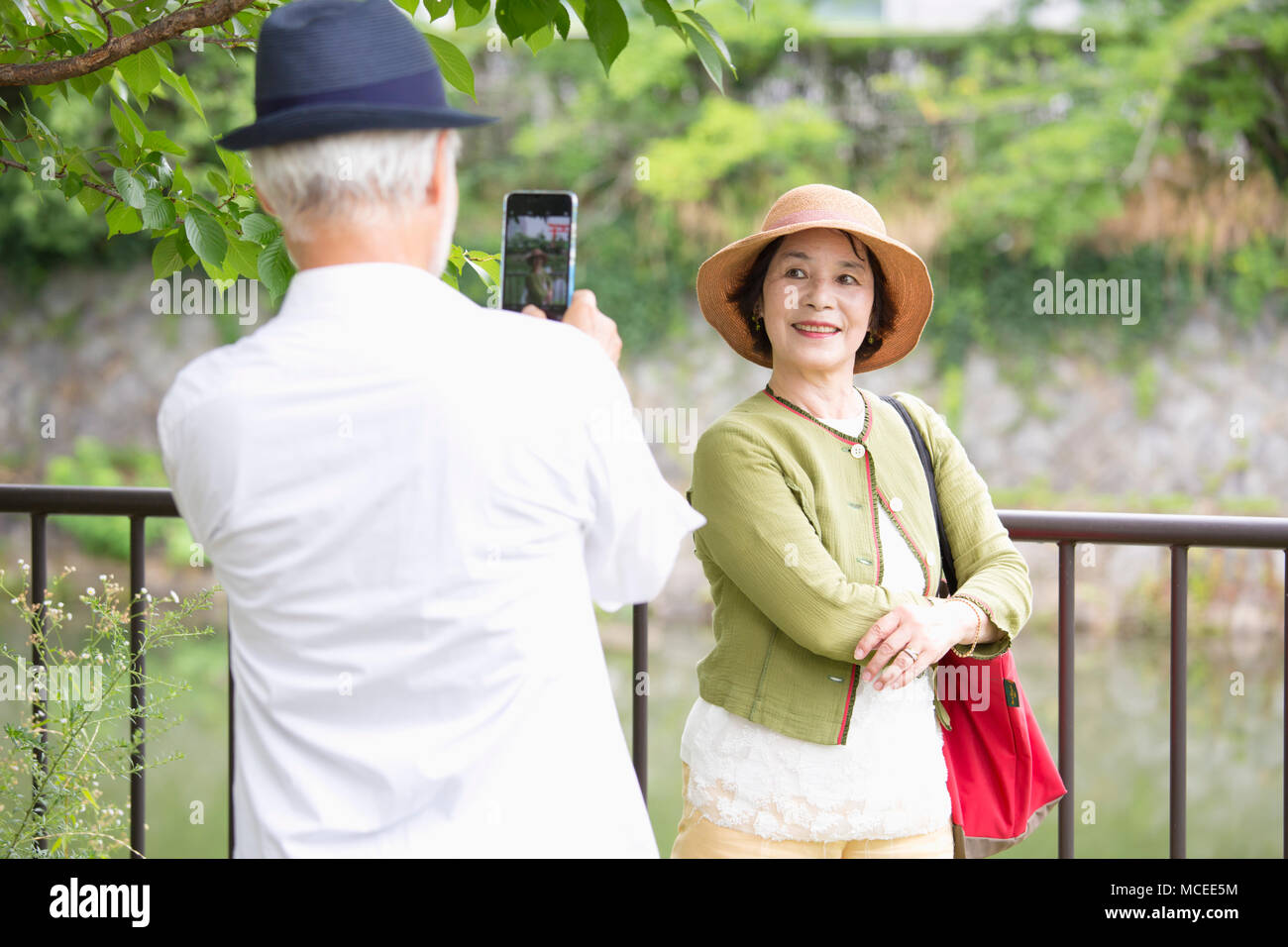 Senior couple taking photos with smart phone Stock Photo - Alamy