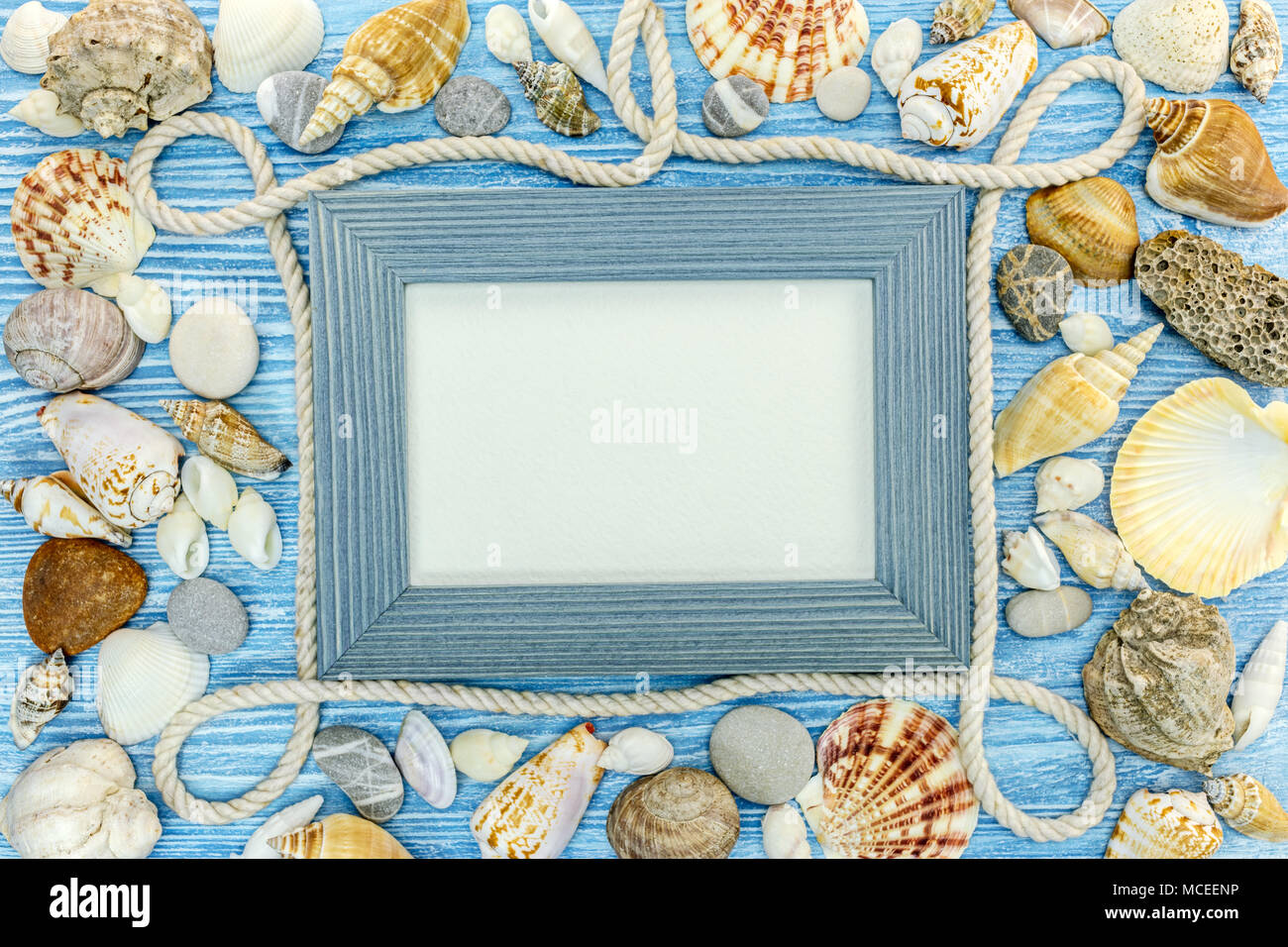sea travel frame decoration on blue background with seashells, stones ...