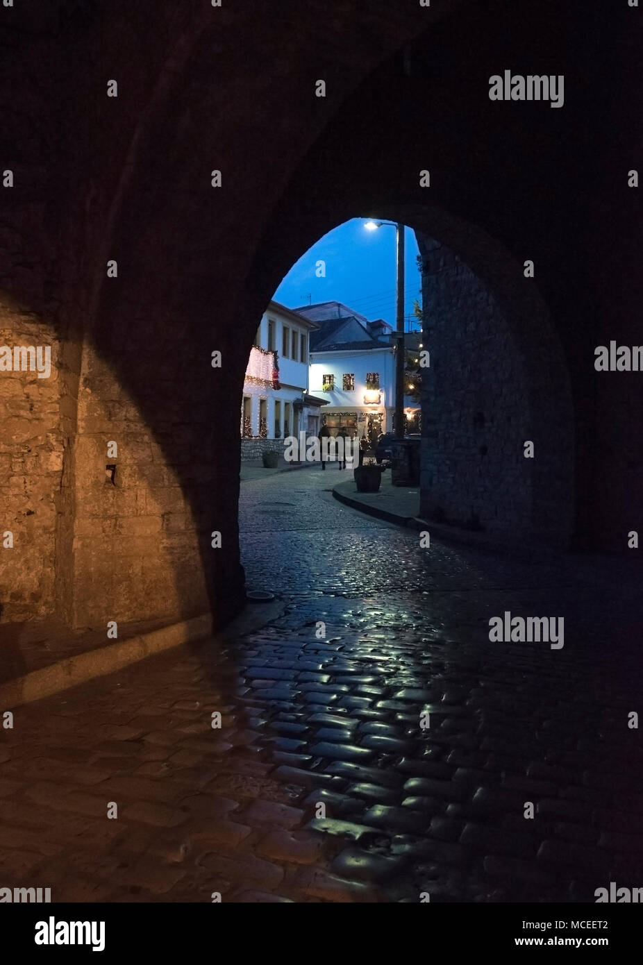 Arch entrance with stone walls to the old city of  Ioannina at night, Greece Stock Photo