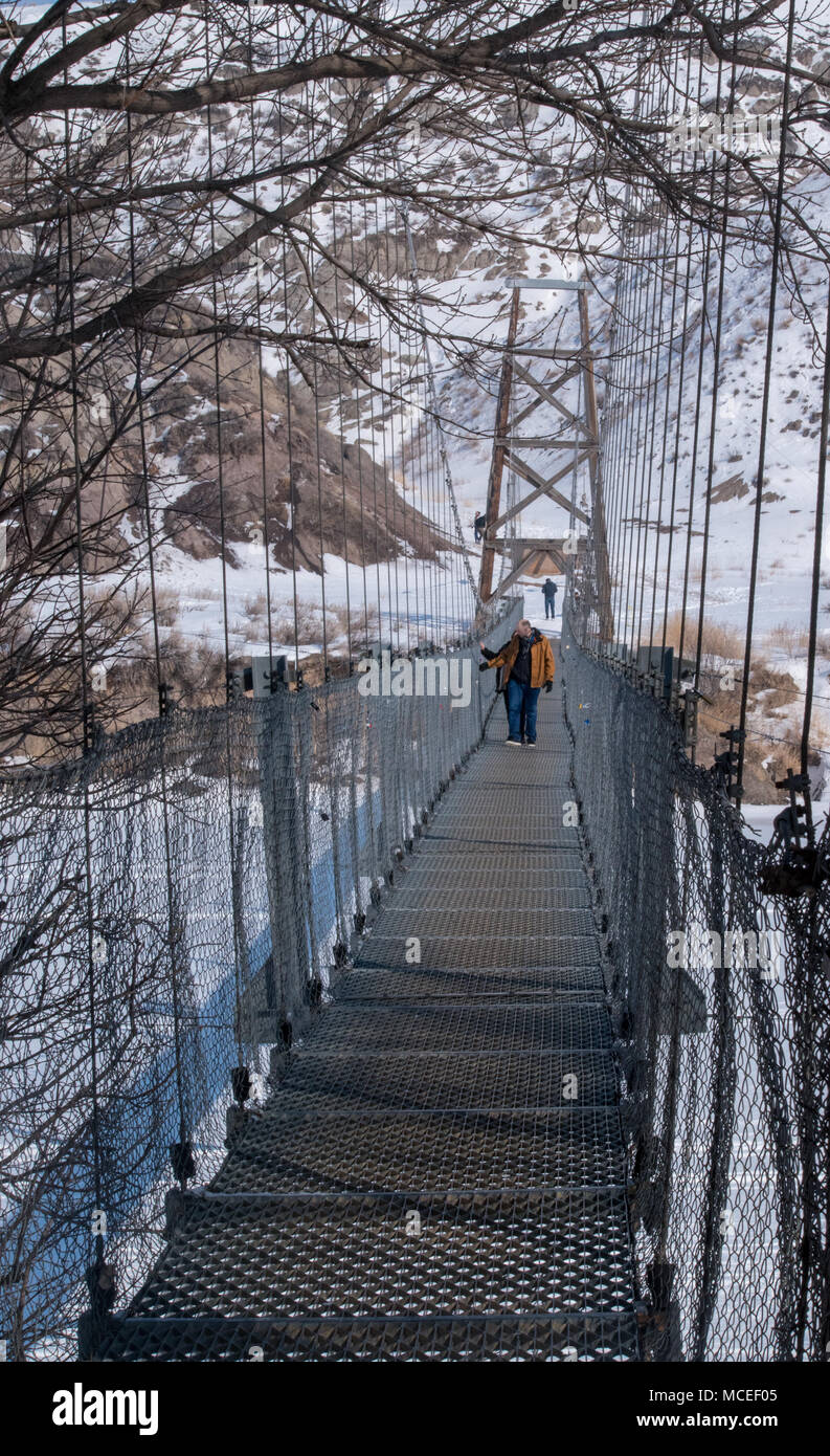 The Star Mine Suspension Bridge is a 117 meter long pedestrian suspension bridge across the Red Deer River in Drumheller, Alberta. Constructed in 1931 Stock Photo