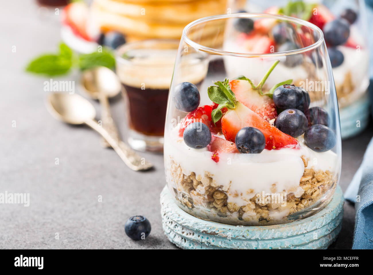 Breakfast with granola, pancakes and berries Stock Photo