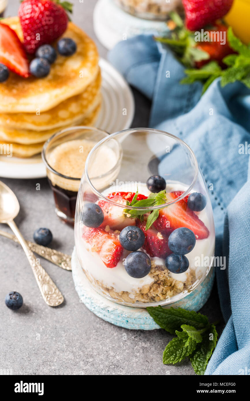 Breakfast with granola, pancakes and berries Stock Photo