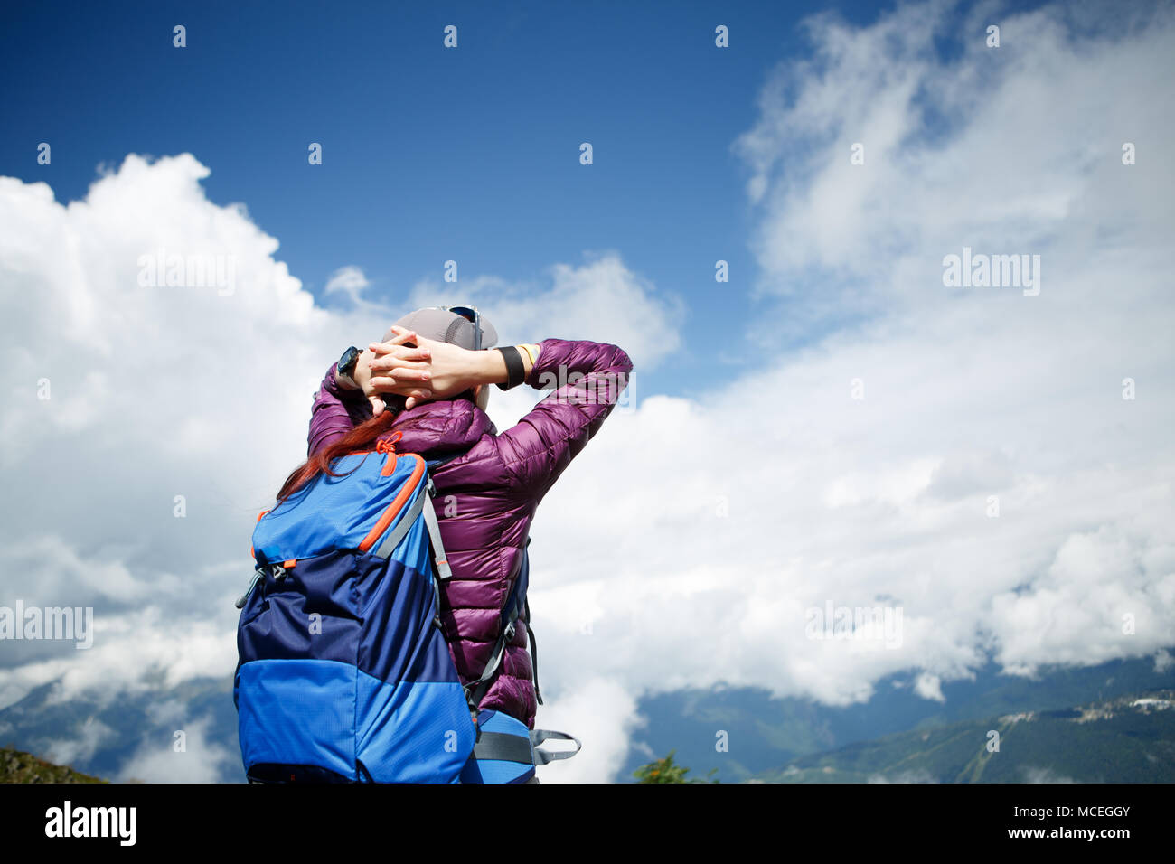 Photo from woman's back with hands behind head Stock Photo