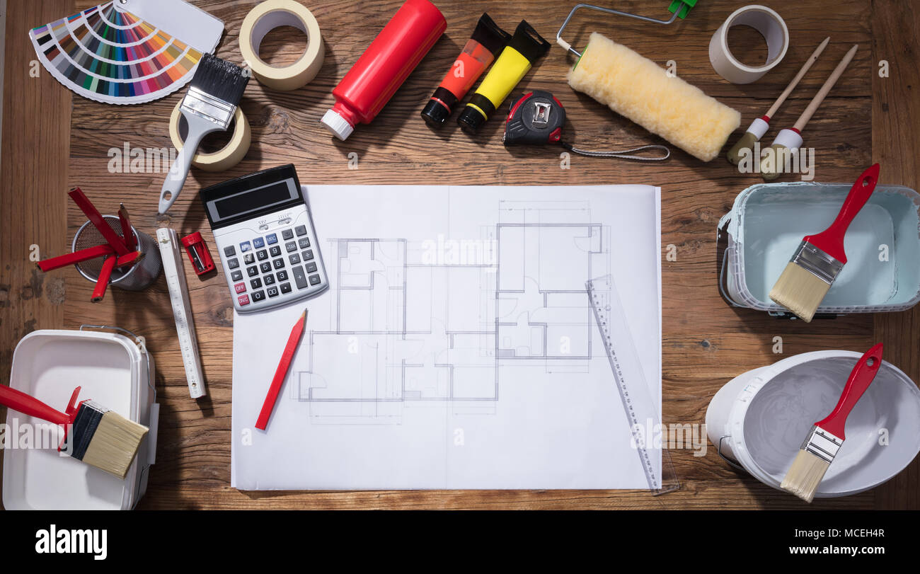 Elevated View Of Blueprint With Paint Brush And Tubes Of Paint On Wooden Background Stock Photo