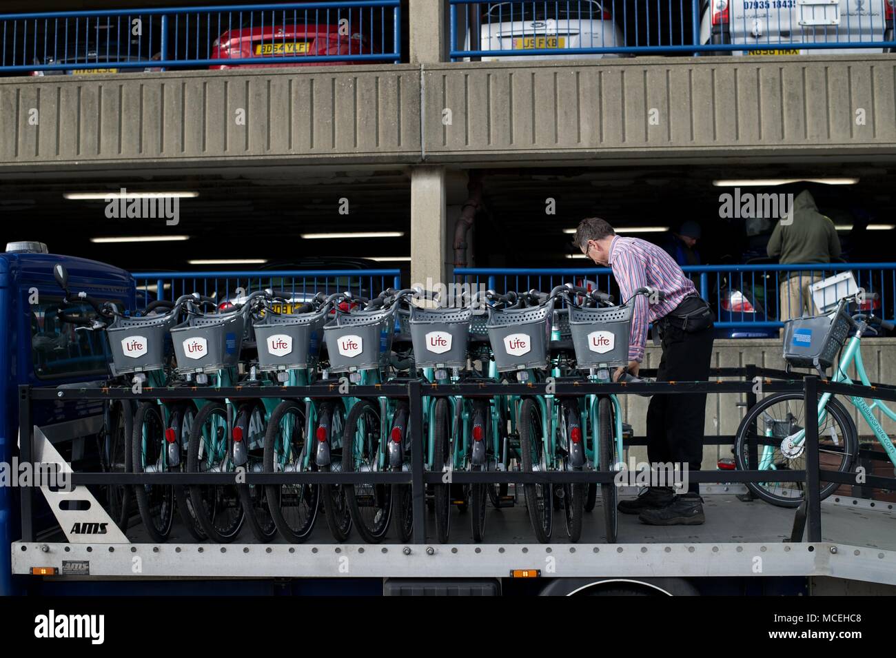 Brighton Bike Hire scheme with man offloading bikes at docking station