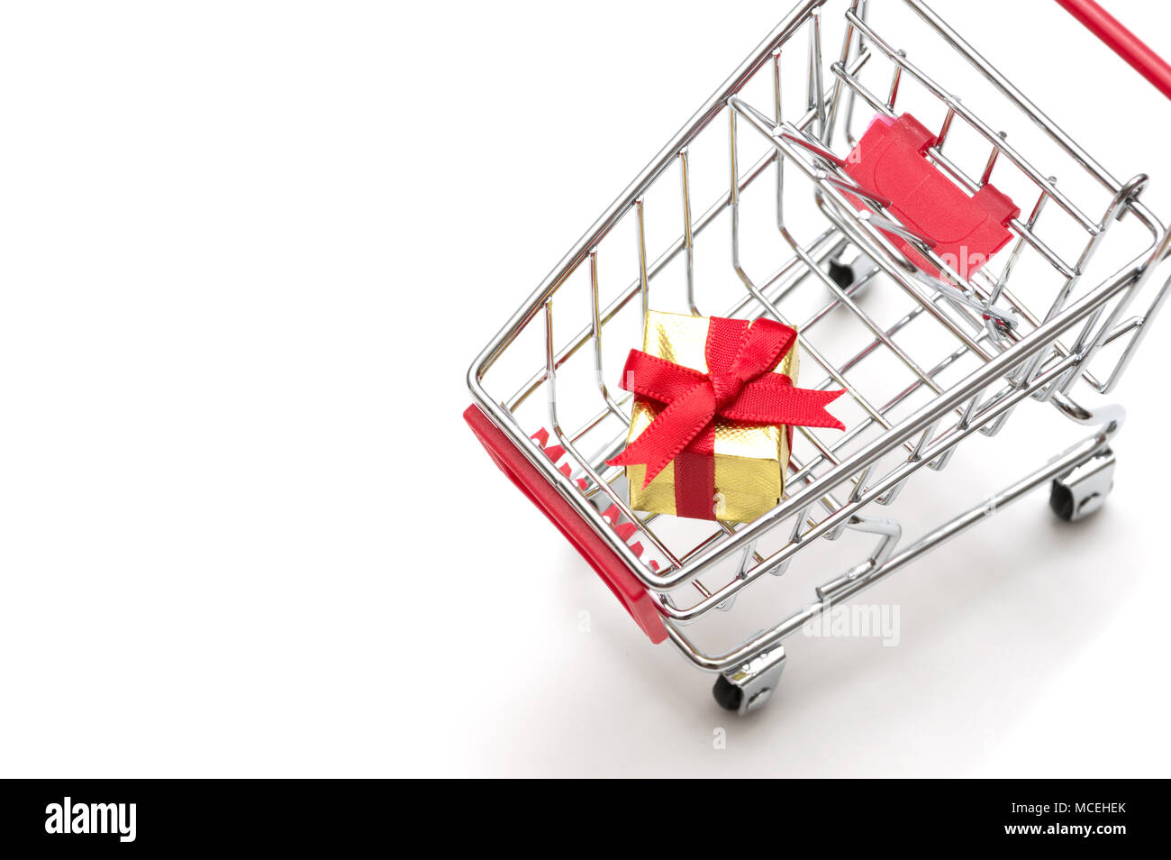 Gift box and shopping cart on white background : economy concept Stock ...
