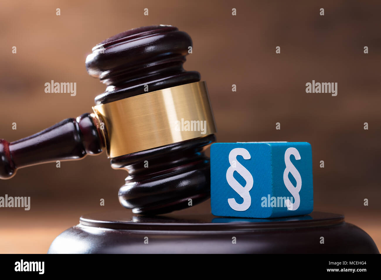 Close-up Of Blue Paragraph Block And Gavel On The Wooden Judge Soundboard Stock Photo