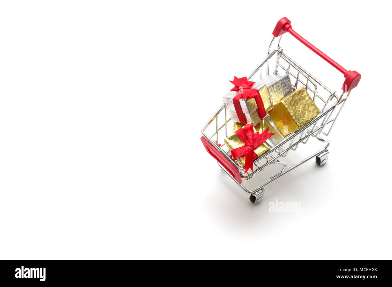 Gift box and shopping cart on white background : economy concept Stock ...