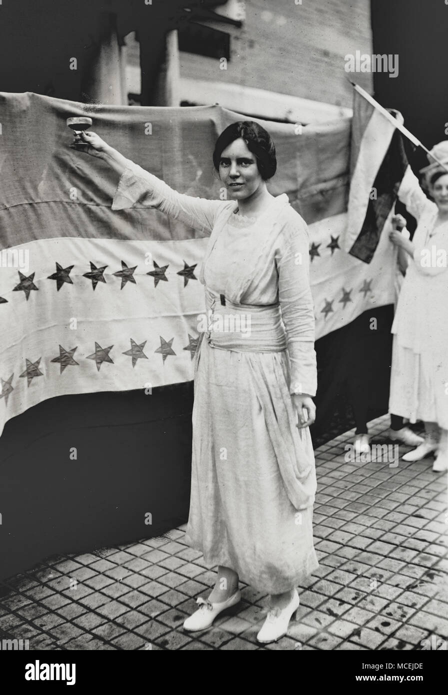 Alice Paul, full-length portrait, standing, facing left, raising glass with right hand, circa 1920 Stock Photo