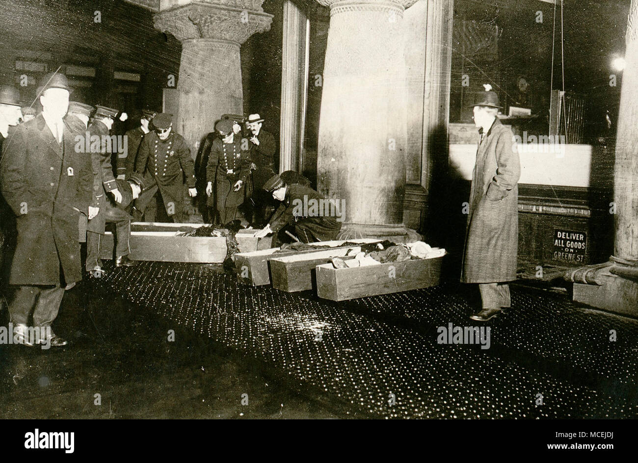 Photograph shows police or fire officials placing Triangle Shirtwaist Company fire victims in coffins. March 25 1911 Stock Photo