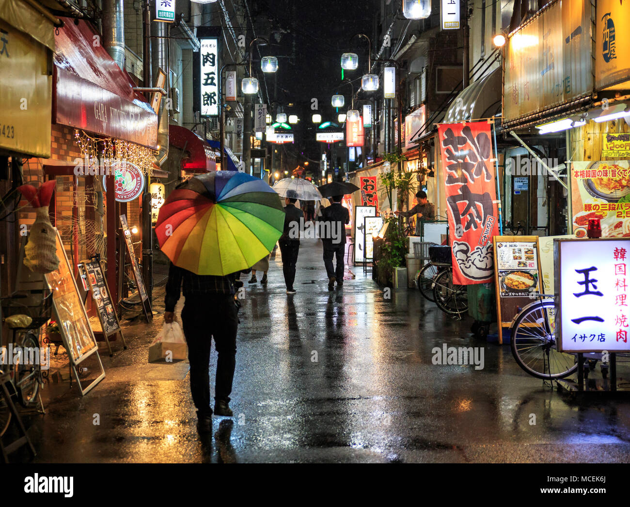 Osaka Japan April 14 18 Man With Rainbow Unbrella Walks In The Rain Through Tenjinbashisuji 6 Chome Stock Photo Alamy