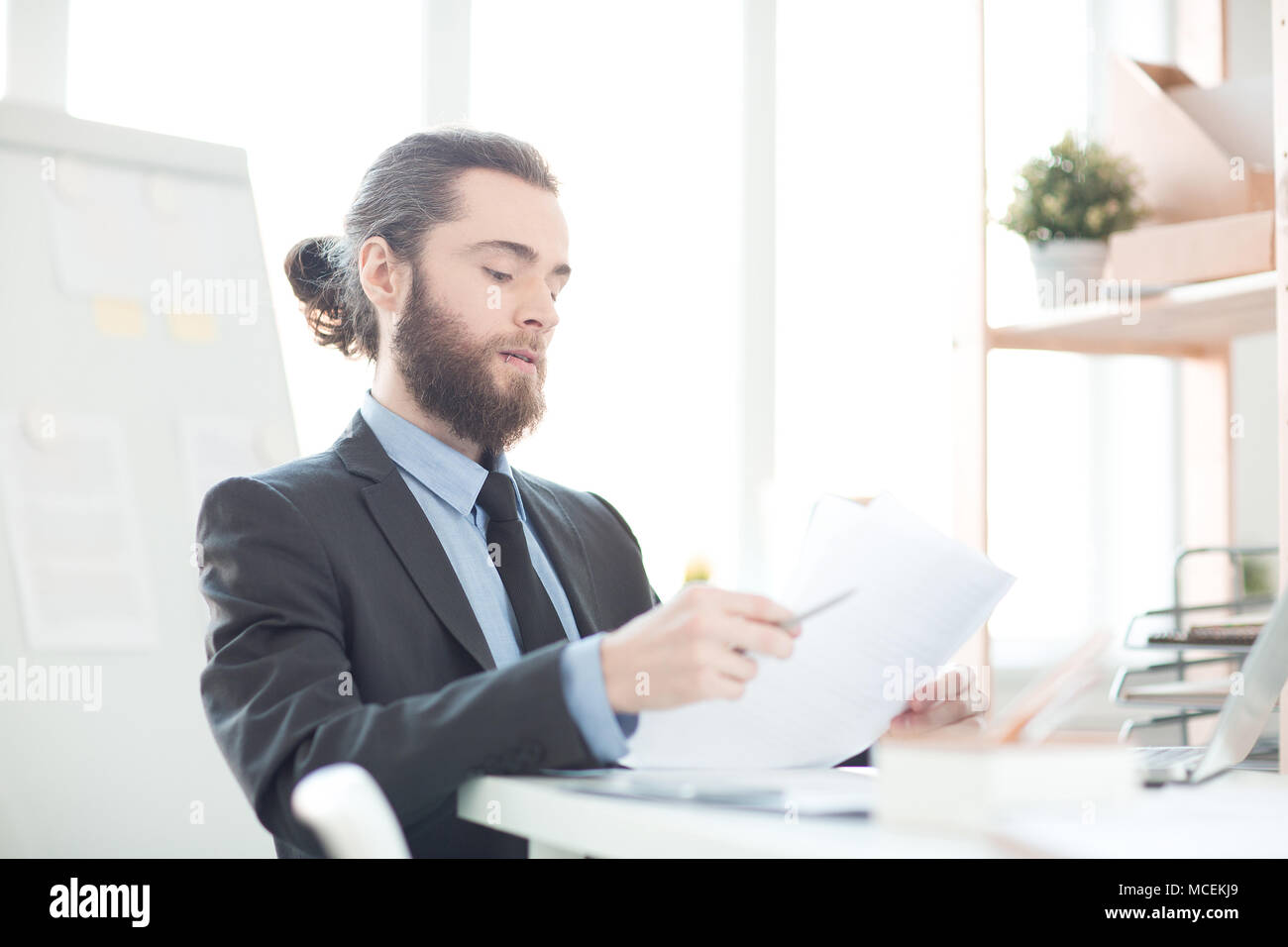 Bearded businessman working with documents at his workplace Stock Photo