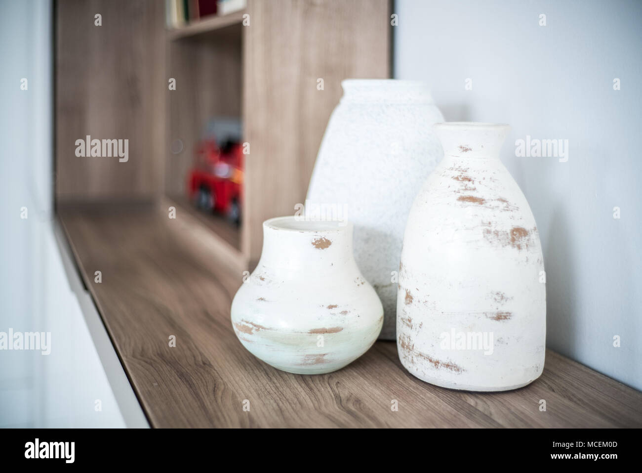 Close-up of vase on wooden shelf Stock Photo
