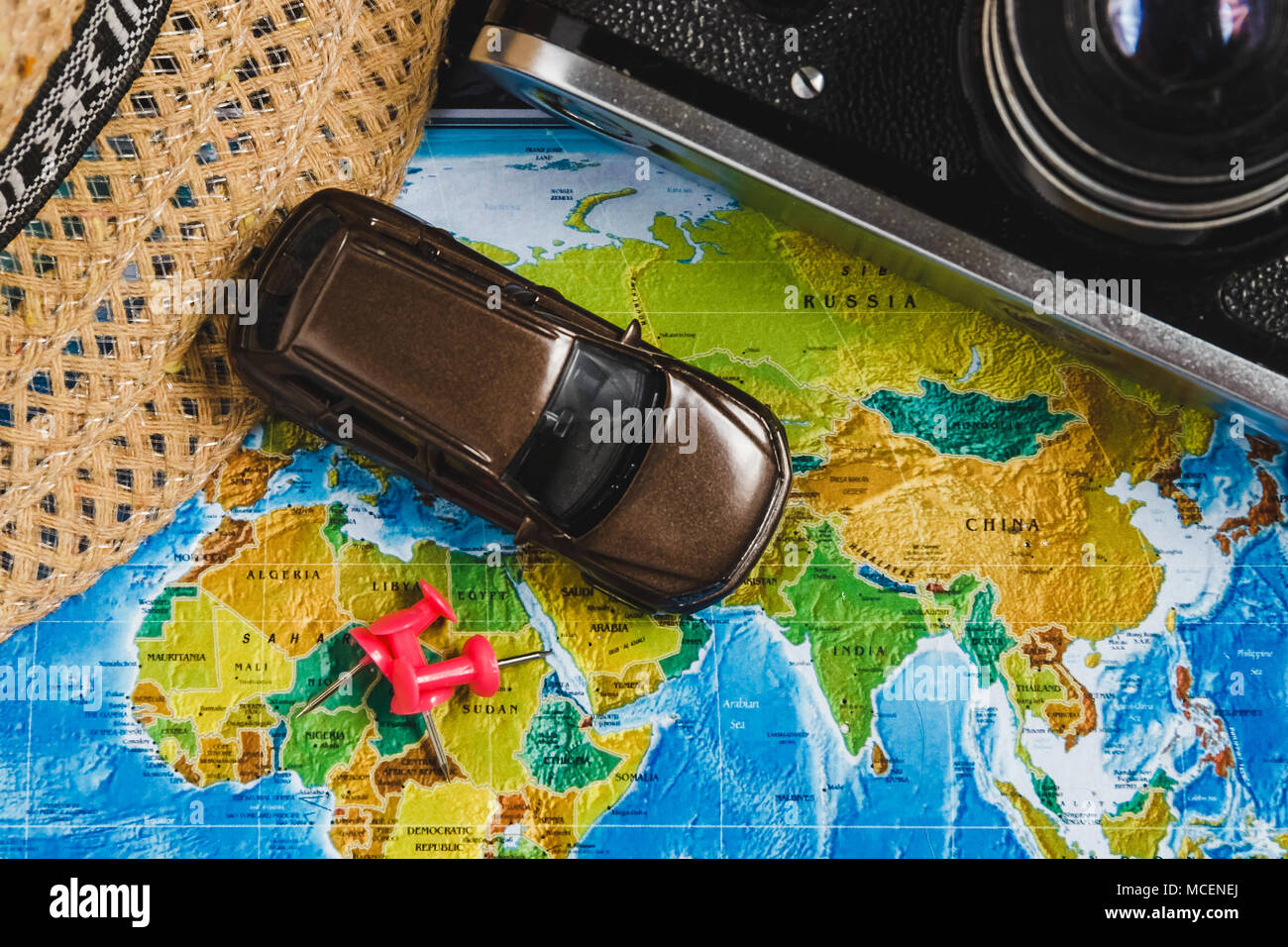 Automotive Travel Destination Points on World Map Indicated with Colorful Thumbtacks, Red Rope and Shallow Depth of Field Stock Photo