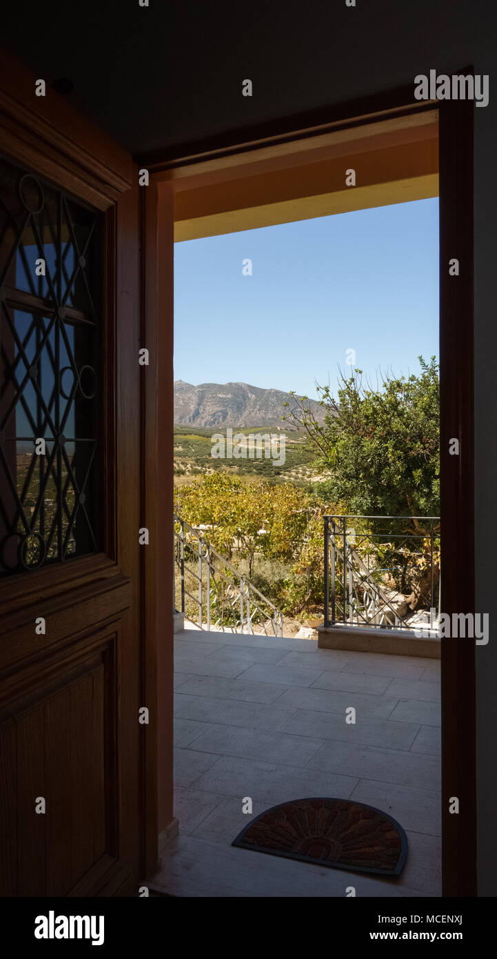 Scenic view of field and mountain from doorway, Crete, Greece Stock Photo