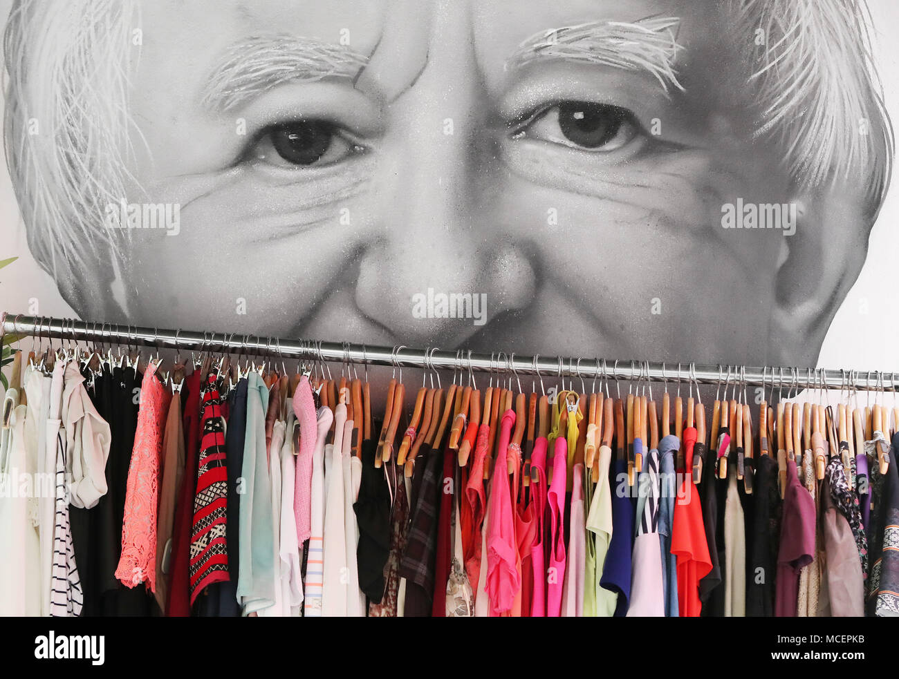 A general view of a clothing rack in front of a Mural of Irish President Michael D Higgins by Subset collective in the Temple Bar area of Dublin The mural is part of the #Greyareaproject, a protest against a recent Dublin City council clamp down on Street art. Stock Photo